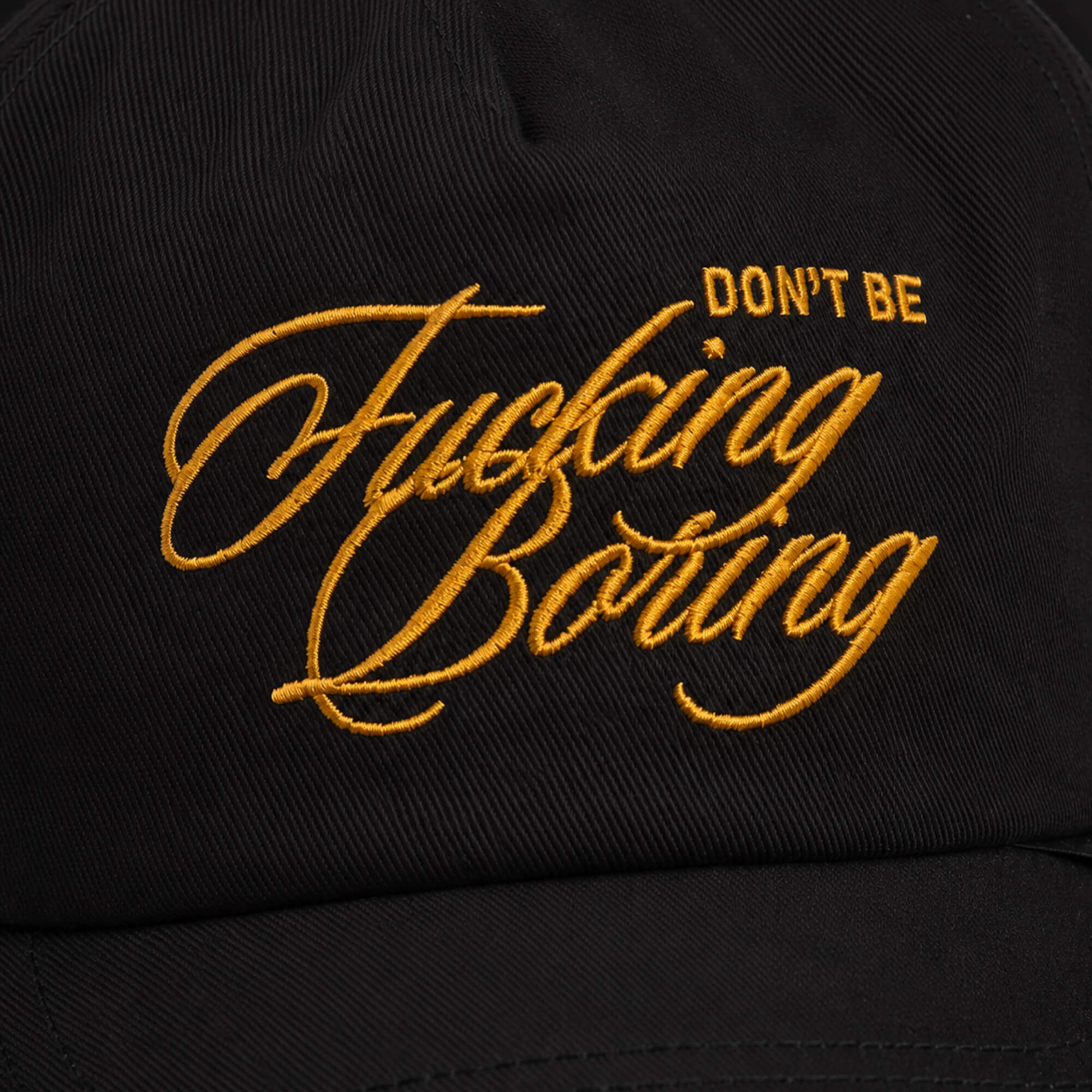 The Goorin Bros. "Don't Be Fucking Boring" cap is a black baseball hat with bold gold embroidered text.
