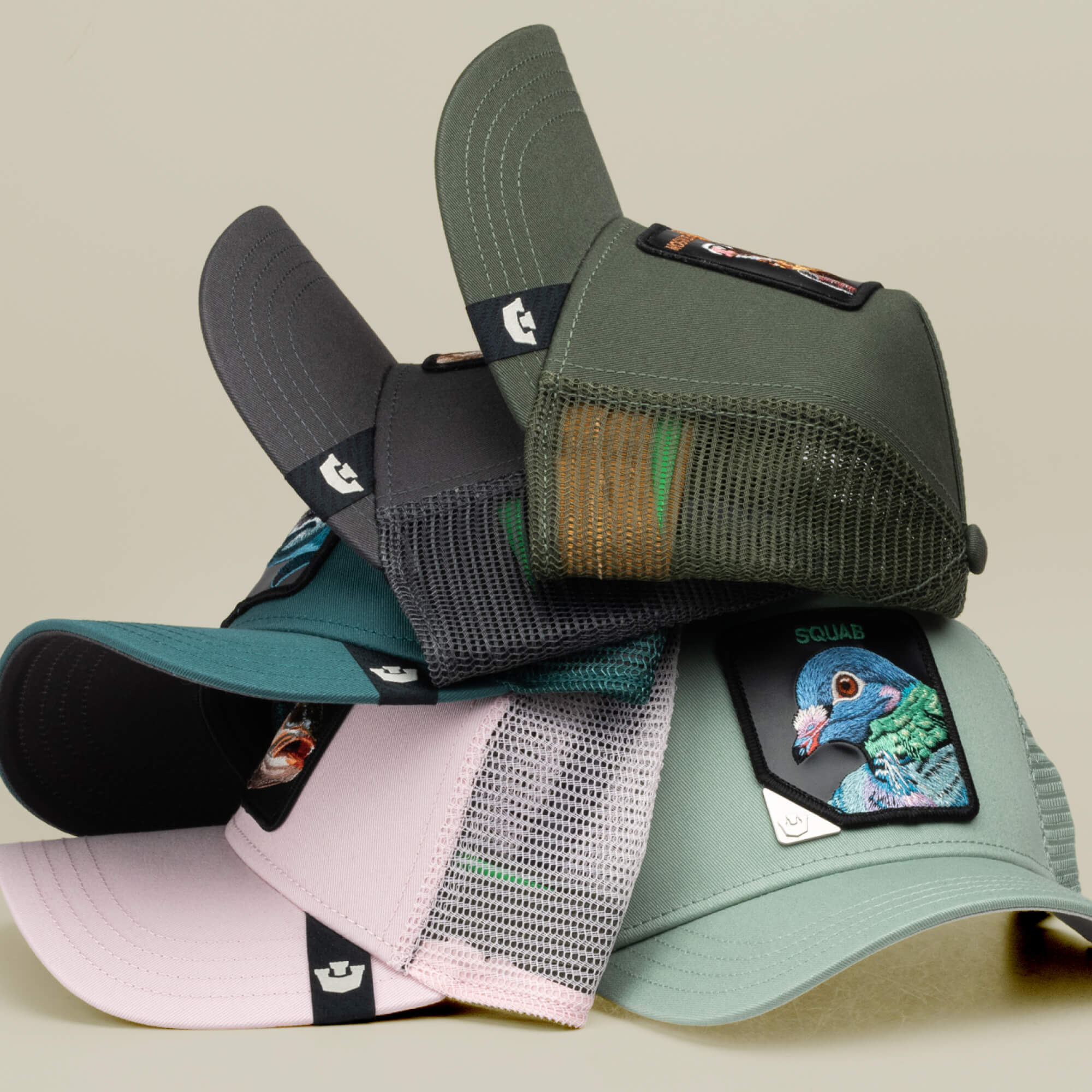 A stack of five Goorin Bros. Blind Box 1: U R WUT U EET trucker hats in assorted colors, each featuring a surprise animal patch on the front, just like opening a mystery box.