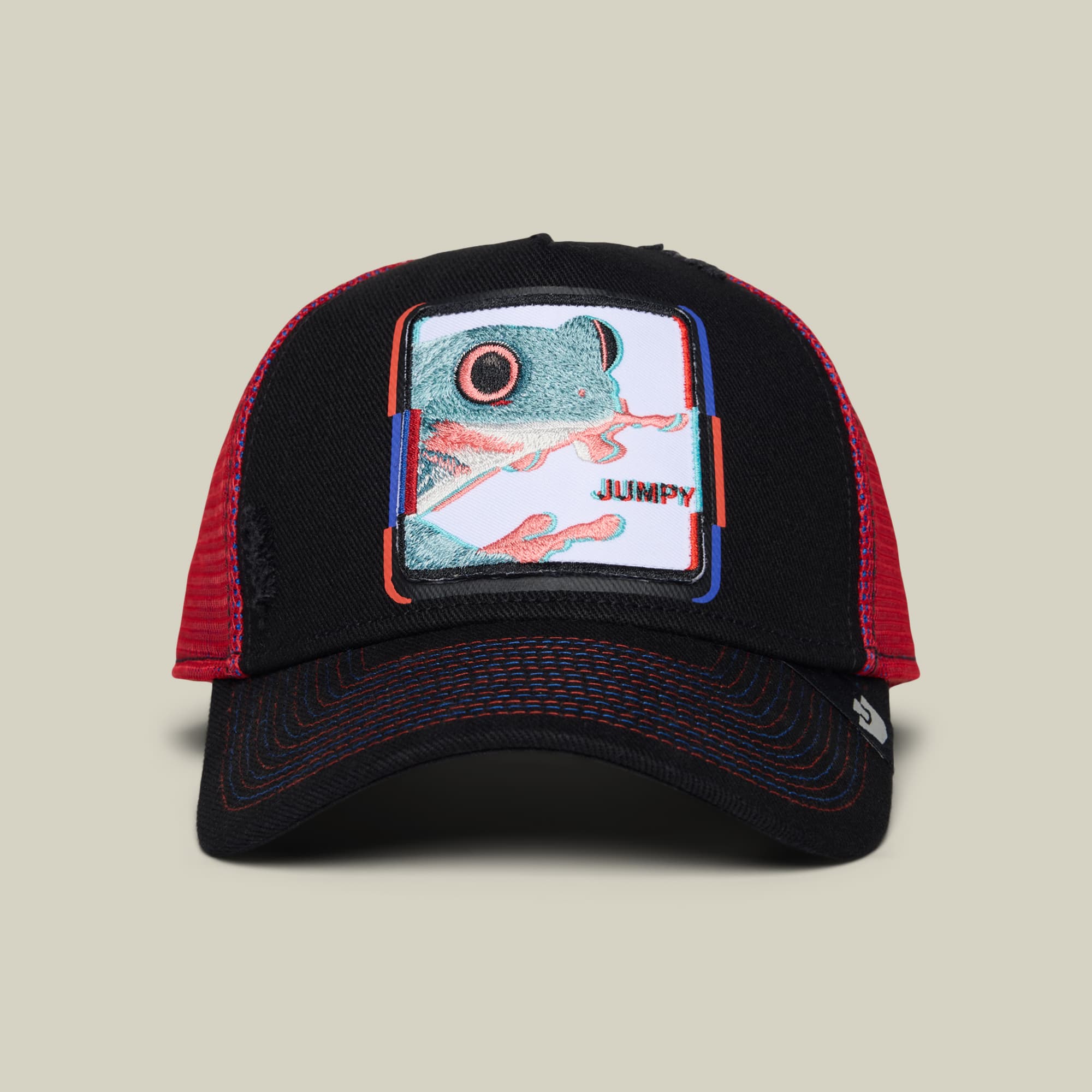 The Goorin Bros. Bug Fixes trucker hat features a black front panel and red mesh back with a colorful embroidered frog patch, coral and blue accents, and text detail, displayed on a neutral background.