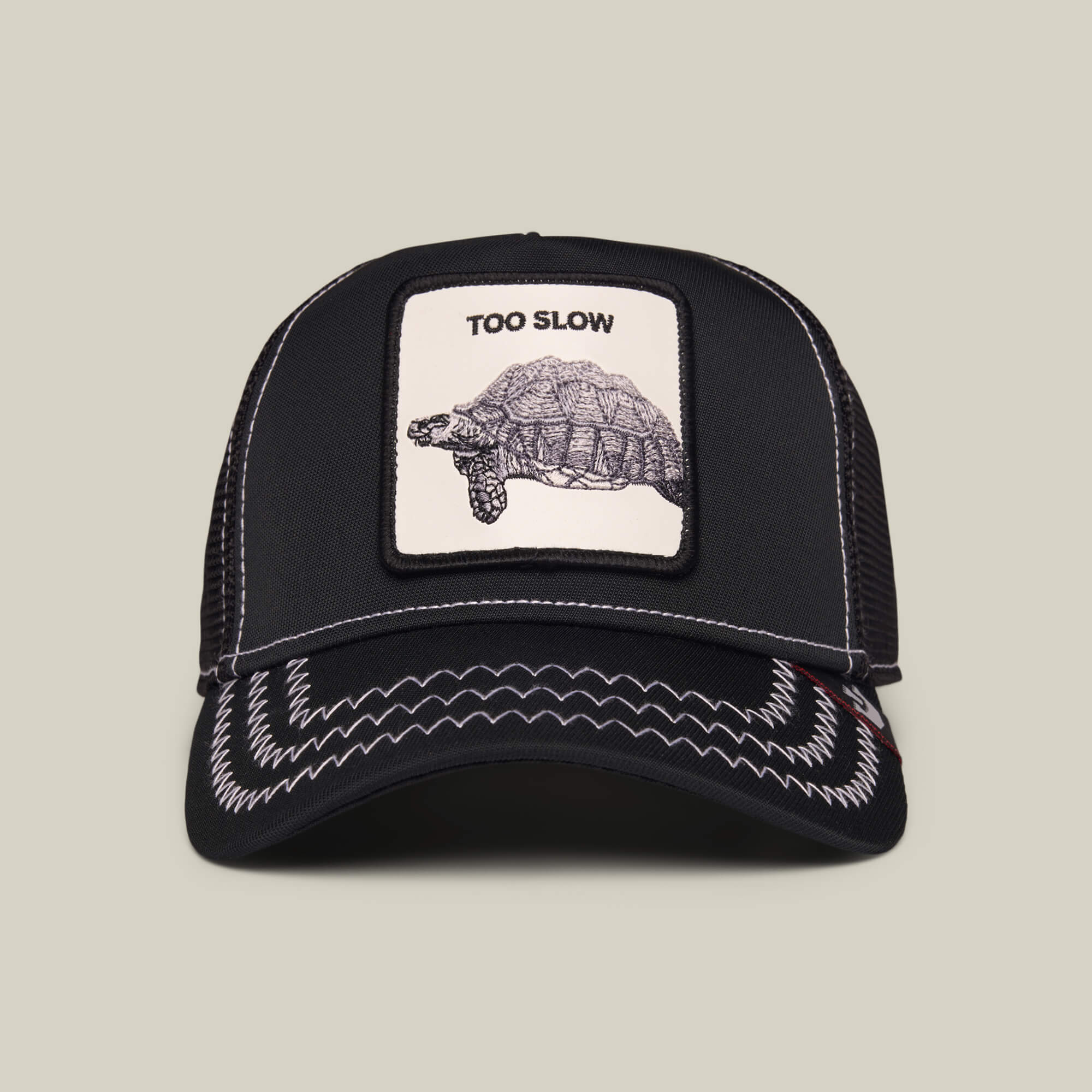 The Goorin Bros. Down Low... cap in Void Black features white stitching and a front patch with a tortoise and the words "TOO SLOW.