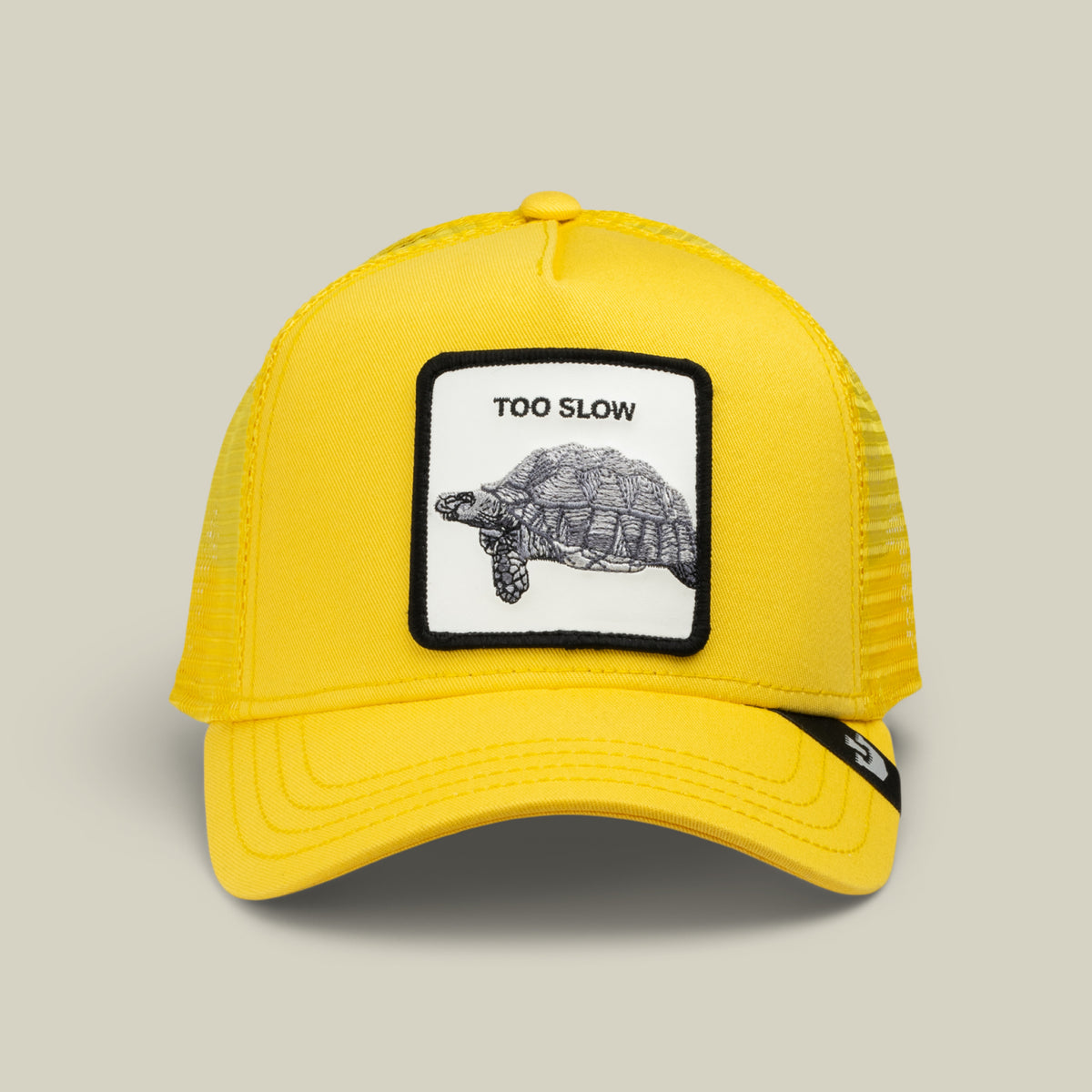 This Beam Yellow “Down Low...” cap by Goorin Bros. features a patch depicting a tortoise with “TOO SLOW” embroidered above it—a true badge of honor from an elusive drop.