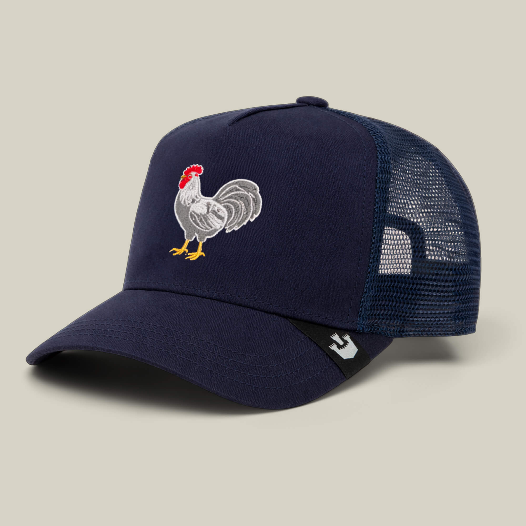 The Goorin Bros. Gone Cockmaxxing trucker hat features a navy blue design, mesh back, and a full front panel embroidered with a rooster.
