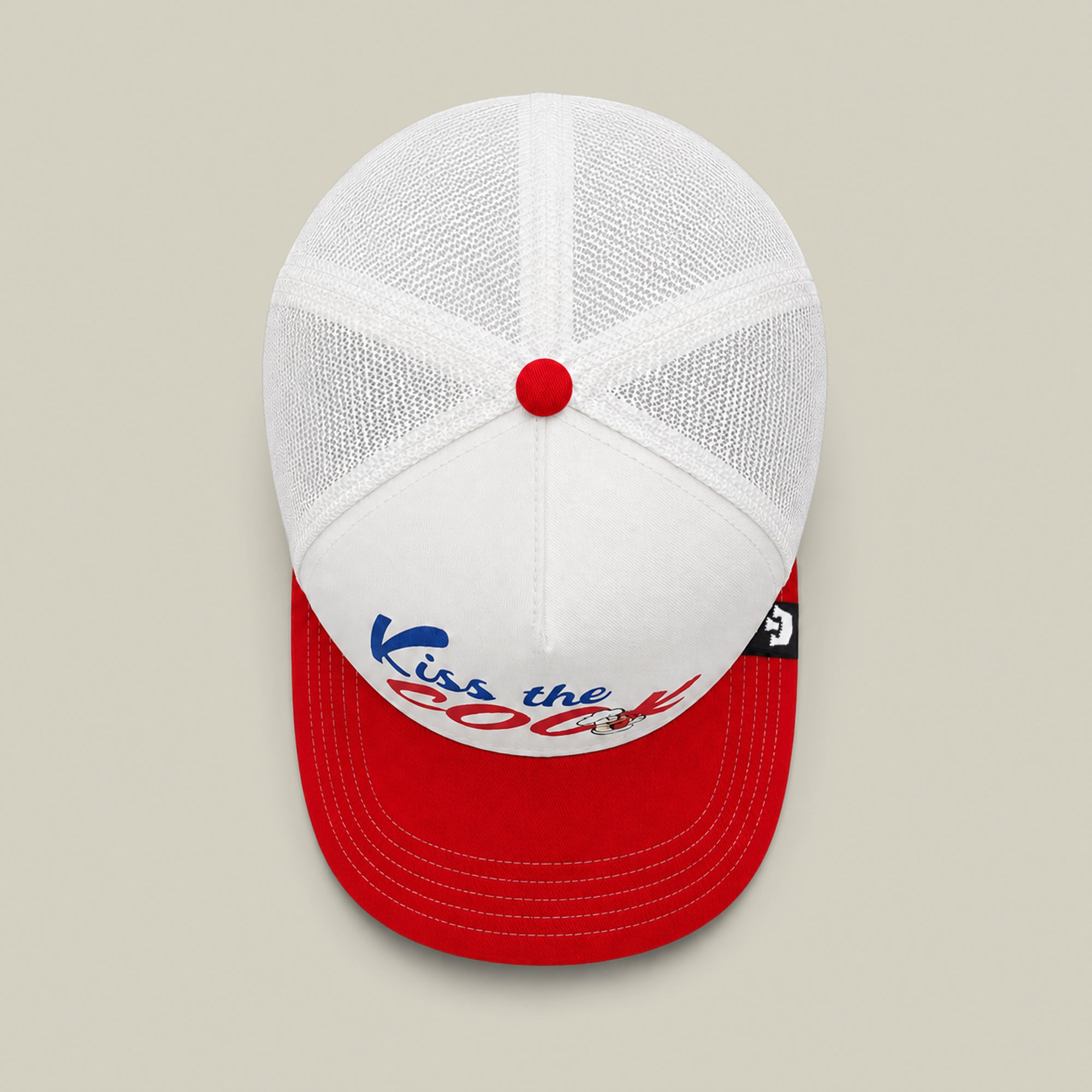 The Goorin Bros. Chef's Kiss hat is a white mesh trucker with a red brim and button, featuring “Kiss the Cook” in blue and red—perfect for any backyard barbecue or grillmaster flipping hot dogs.