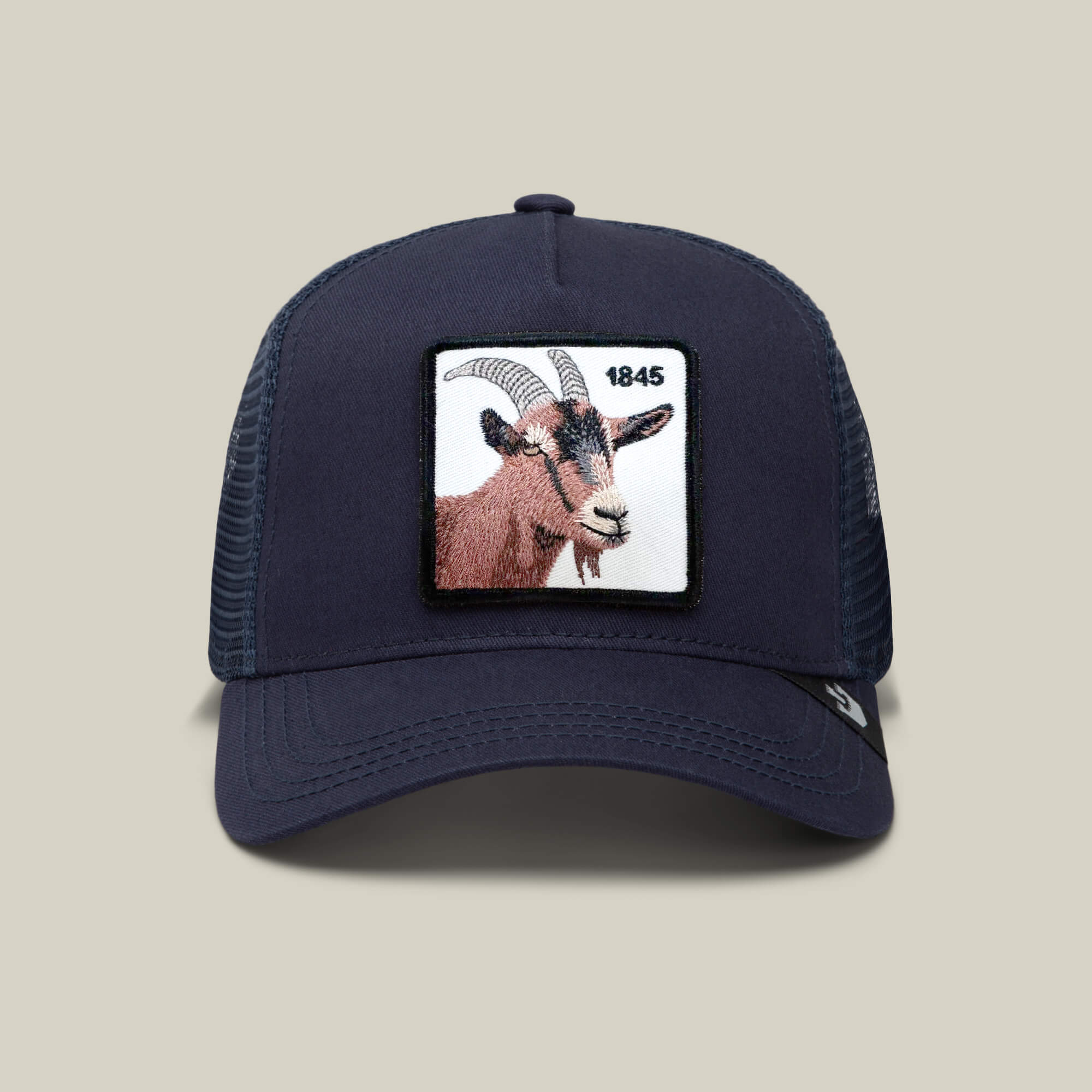 The Goorin Bros. 1845 Goat is a navy blue mesh trucker hat featuring a front rectangular patch with a goat's head and "1845" in black text.