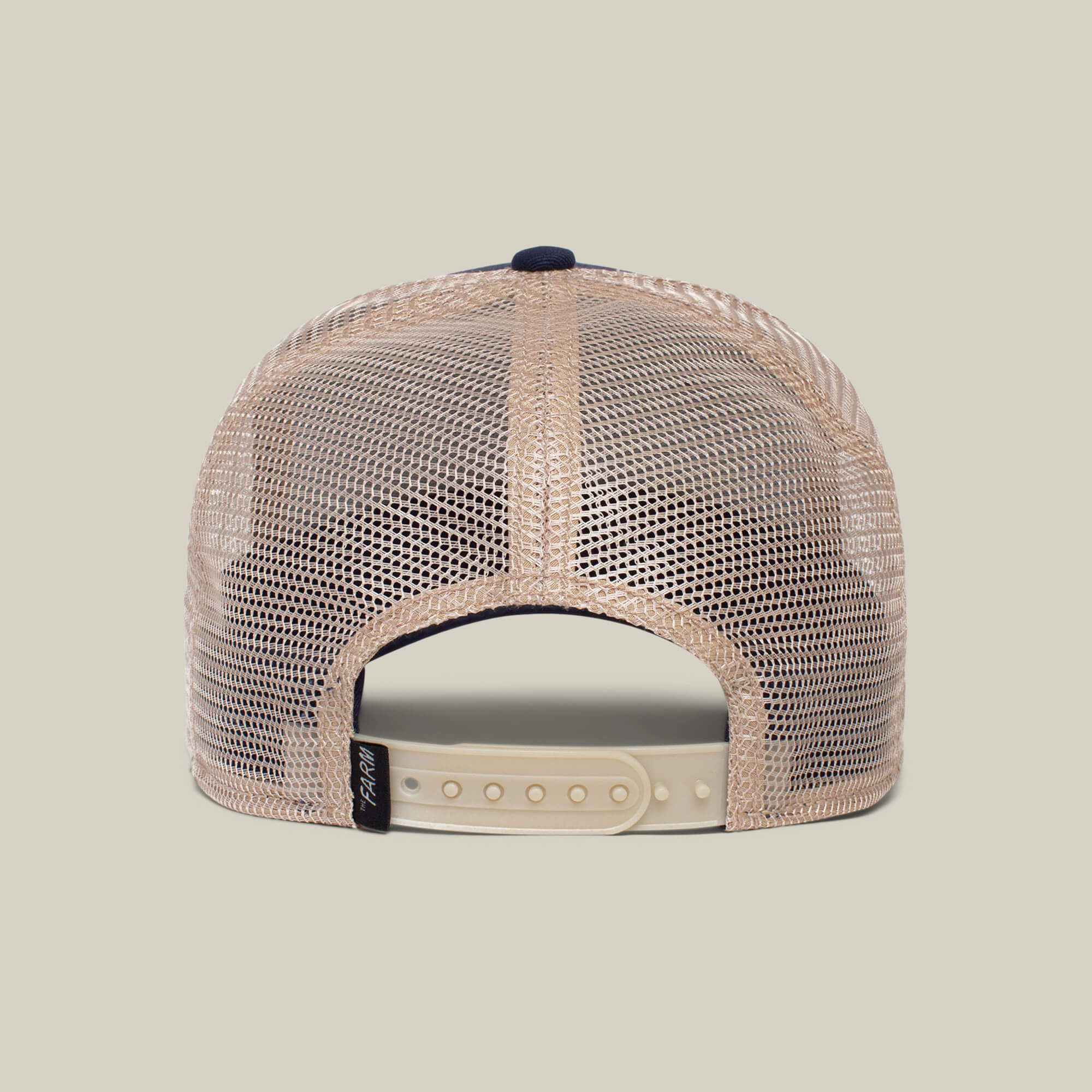 Rear view of the Goorin Bros. 1802 Mule beige mesh trucker hat featuring an adjustable snapback closure and a small black tag on the left side.