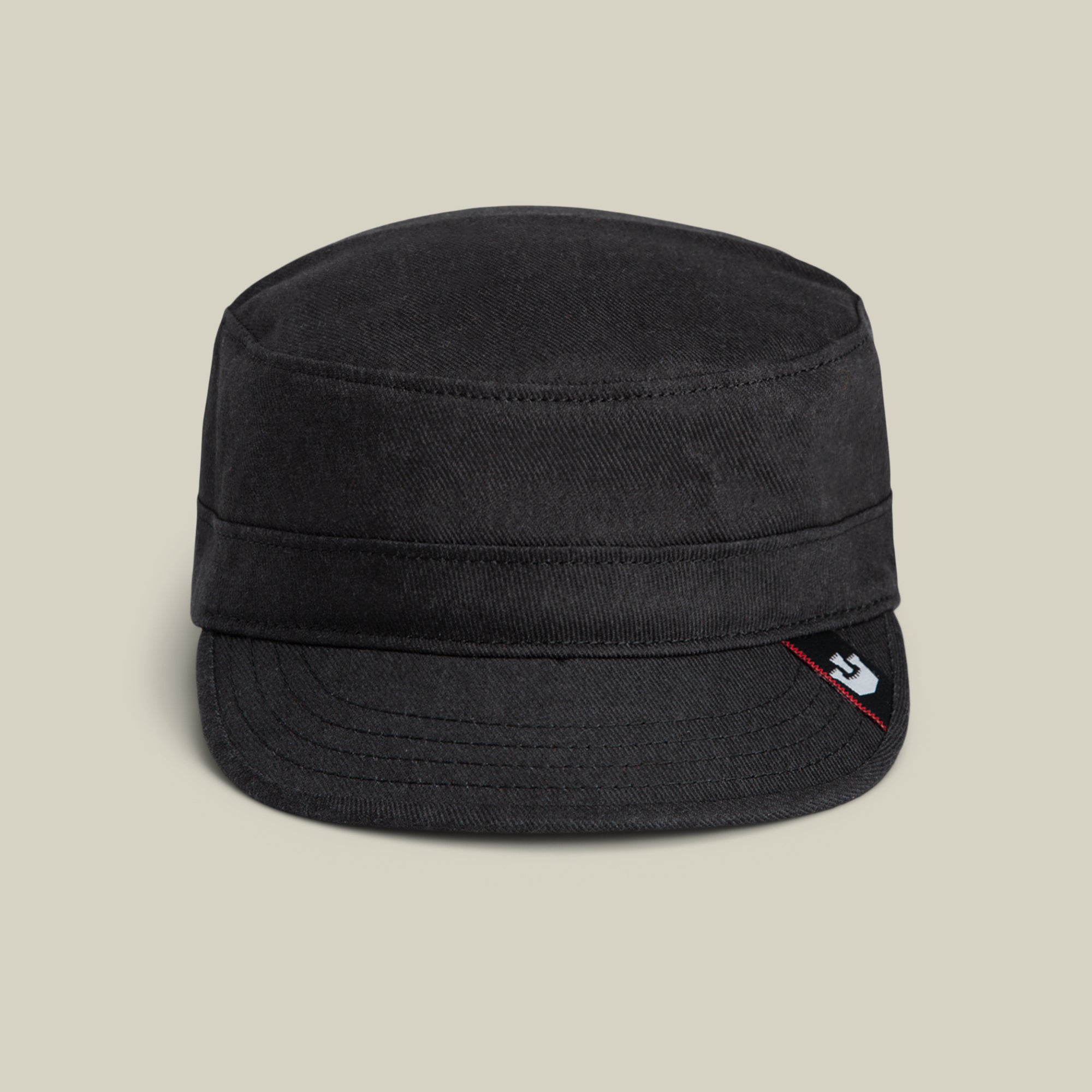 The Goorin Bros. Home at Last is a stylish black military-style cap with a short flat brim and a small logo tag on the front right side, shown against a plain beige background.