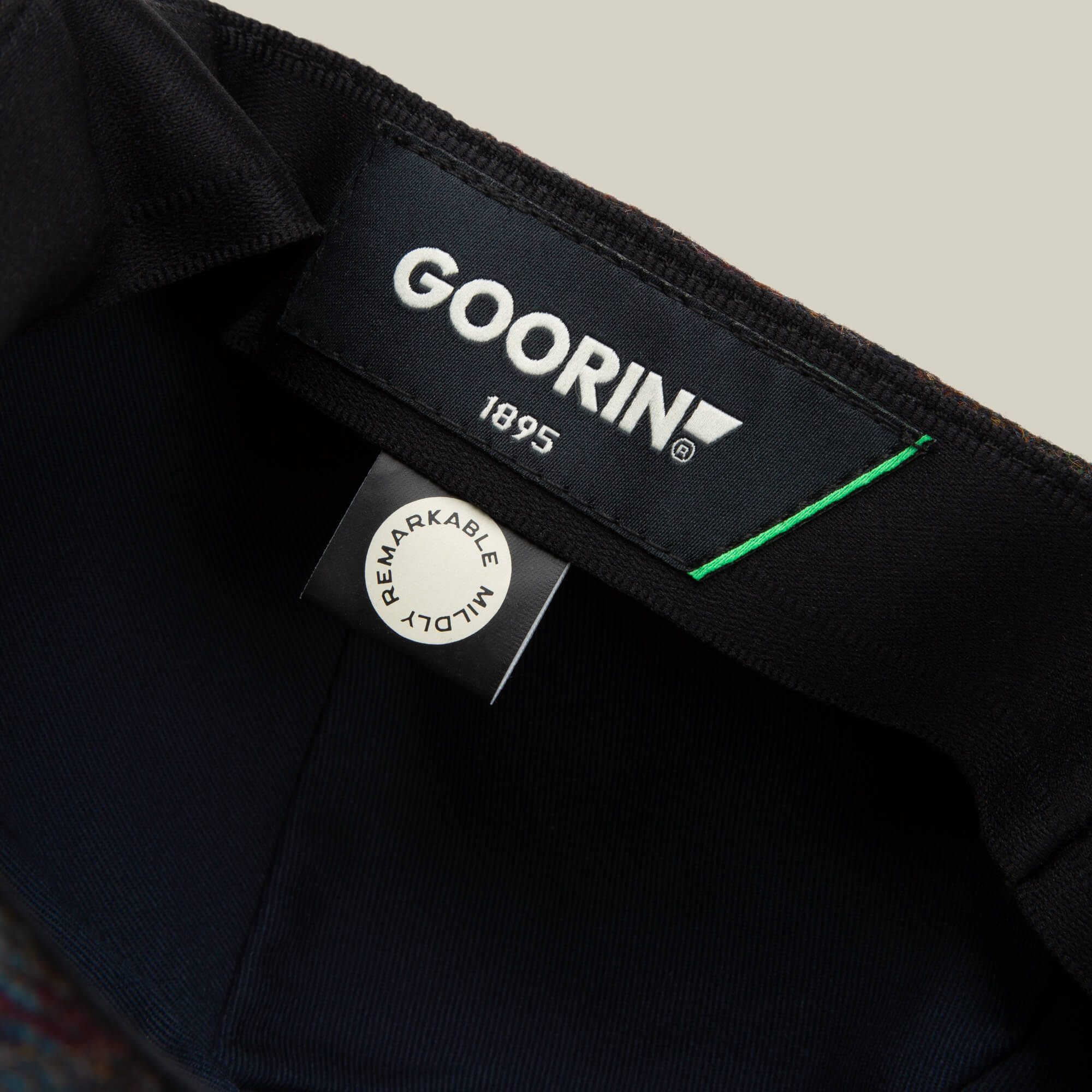 Close-up of the inside label on the Cozy Benjamin Paul hat by Goorin Bros., showing the brand name, year 1895, and a tag that reads “REMARKABLY WELL MADE.”.