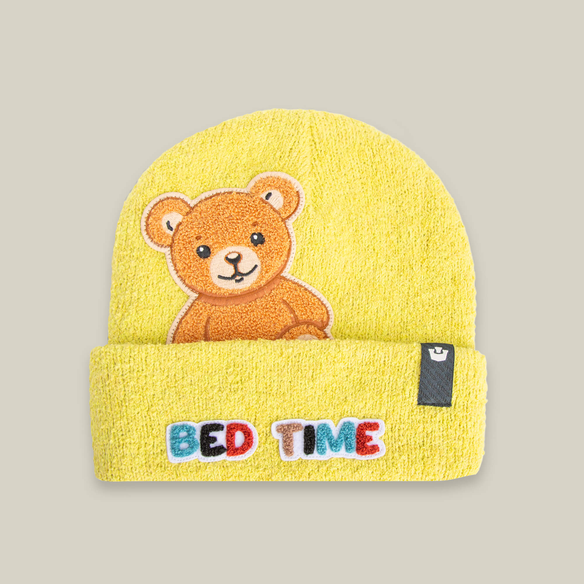 The Nap World beanie by Goorin Bros. in BEAM features a soft knit yellow design with an embroidered teddy bear and "BED TIME" on the front—perfect for fans of the sleepy bear beanie style.