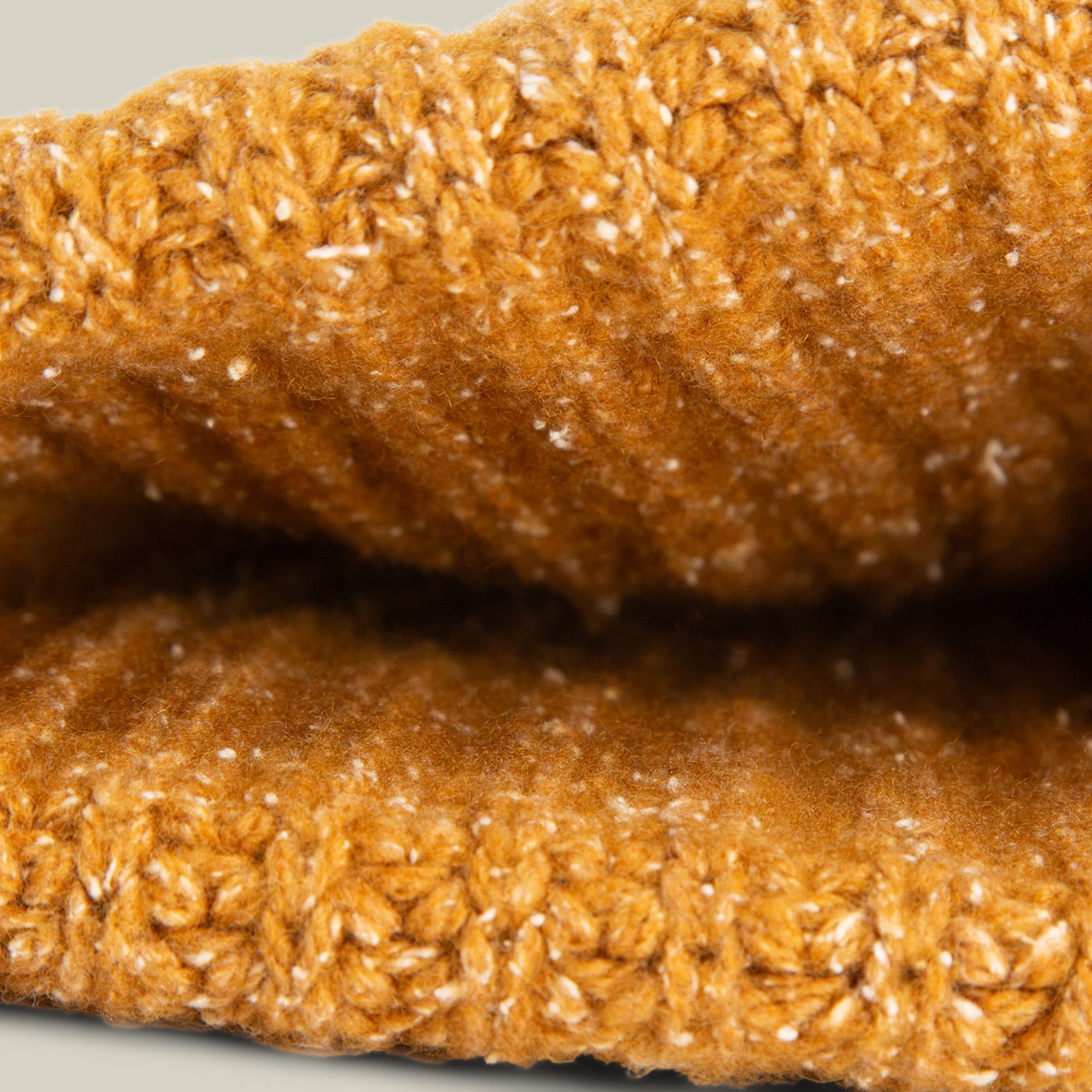 Close-up of the Northstar beanie by Goorin Bros. in mustard yellow, highlighting its textured knit pattern and visible stitches.