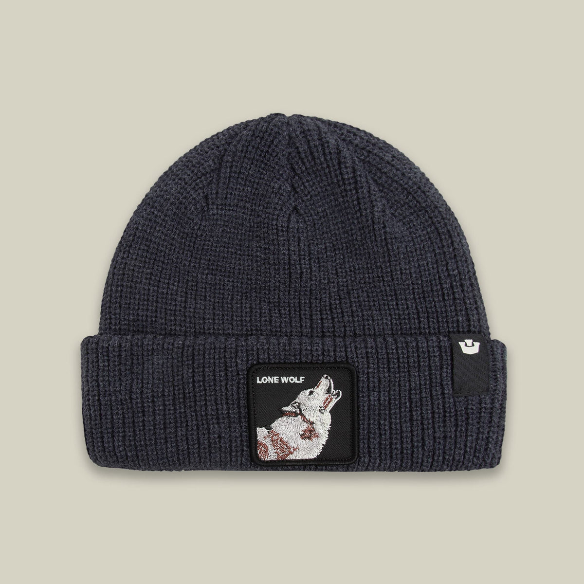 The Lone Wolf Beanie by Goorin Bros is a charcoal gray ribbed knit beanie featuring an embroidered wolf patch on the front with "Lone Wolf" text on a black label.