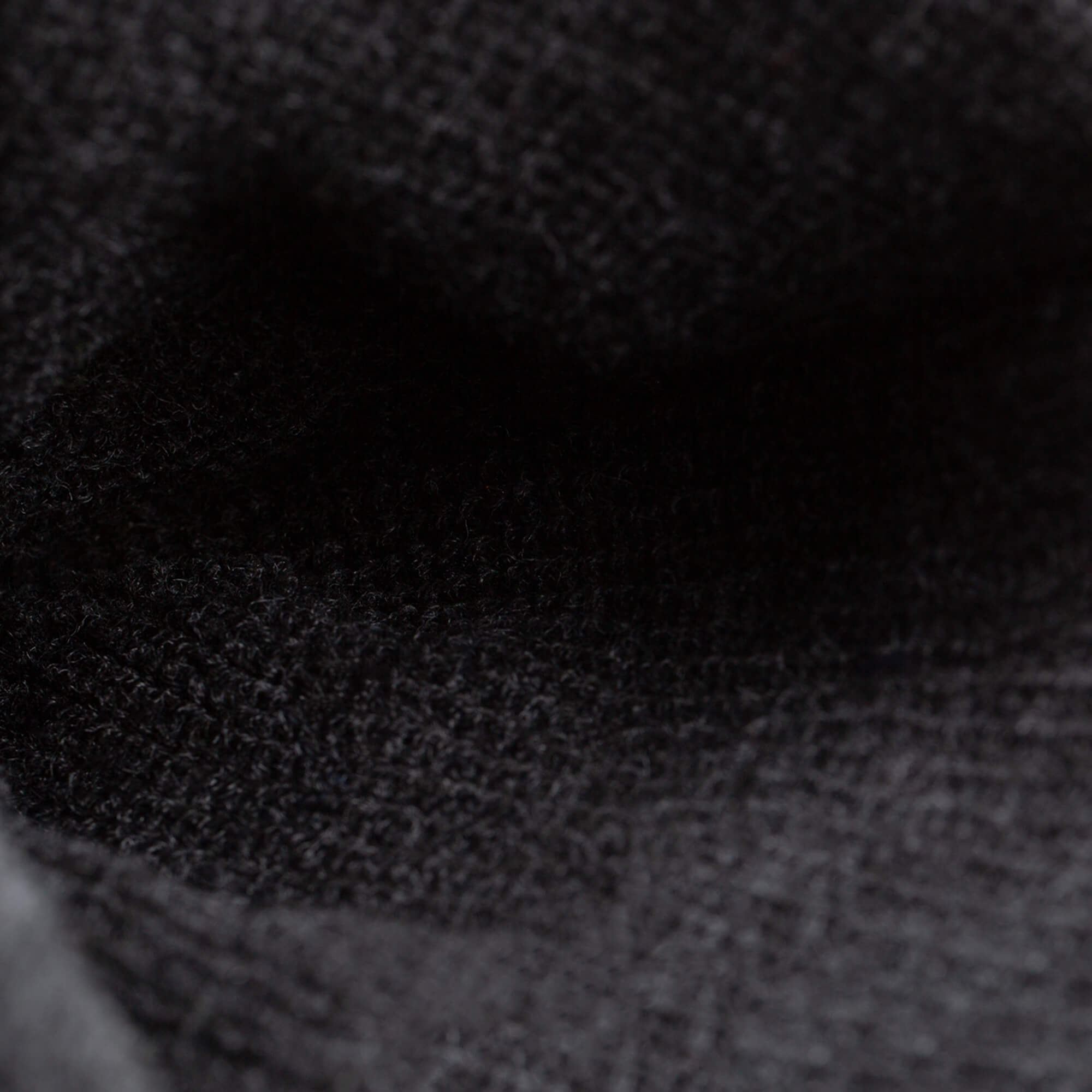 Close-up of The Savage Beanie by Goorin Bros.—a black knit hat with detailed texture and visible fibers that highlight its cozy craftsmanship.