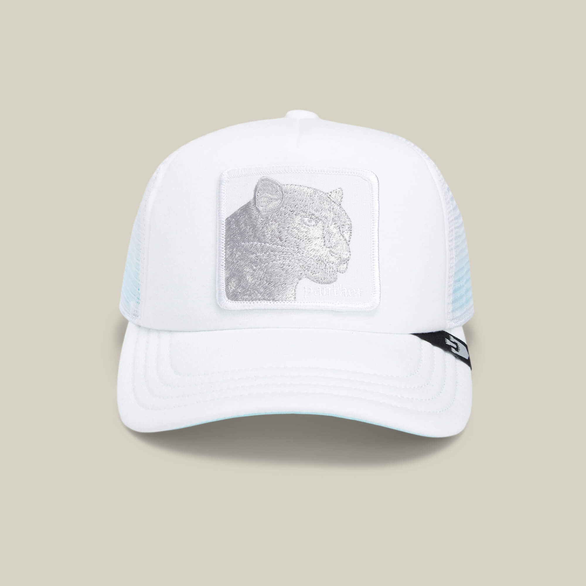 The Lil Pantherino by Goorin Bros. is a white mesh trucker hat with a breathable design, featuring an embroidered panther patch on the front and a black logo tag on the right side of the brim.