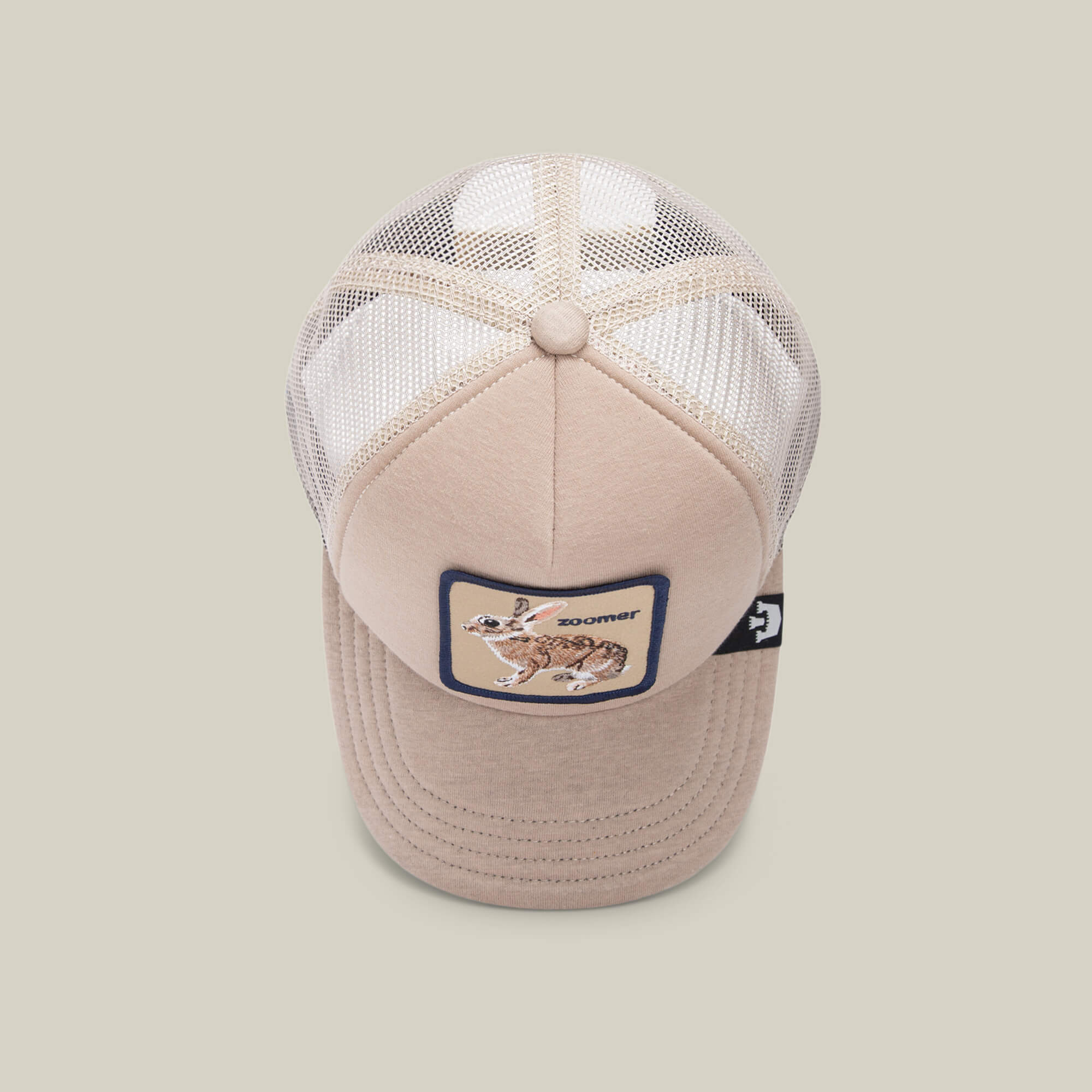 The OK Zoomer by Goorin Bros. is a beige mesh hat with a breathable back and a front embroidered patch showing a jackrabbit and the word "Zooner.