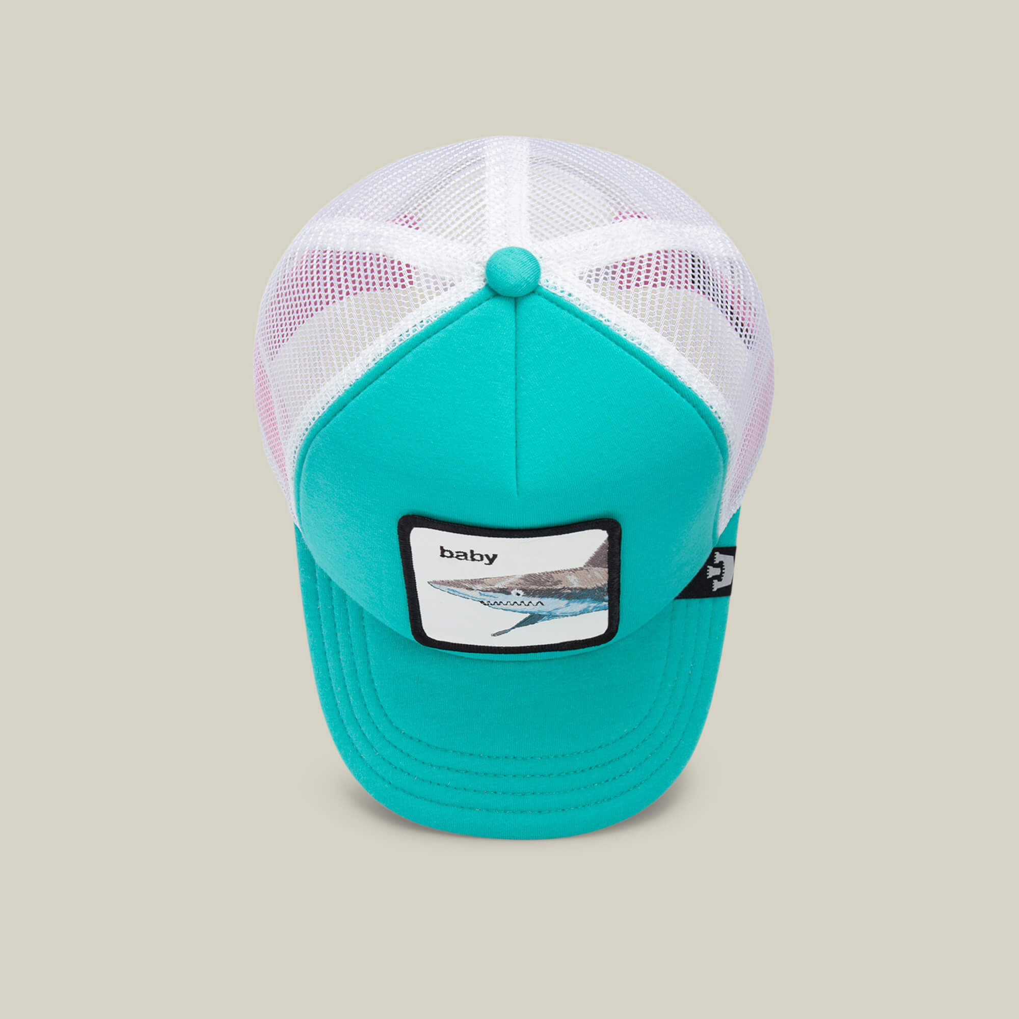 A turquoise and white mesh trucker hat by Goorin Bros., named “Do Do Doodoo Doodoo,” makes a perfect aqua kids cap and features a front patch with the word “baby” alongside an abstract design.