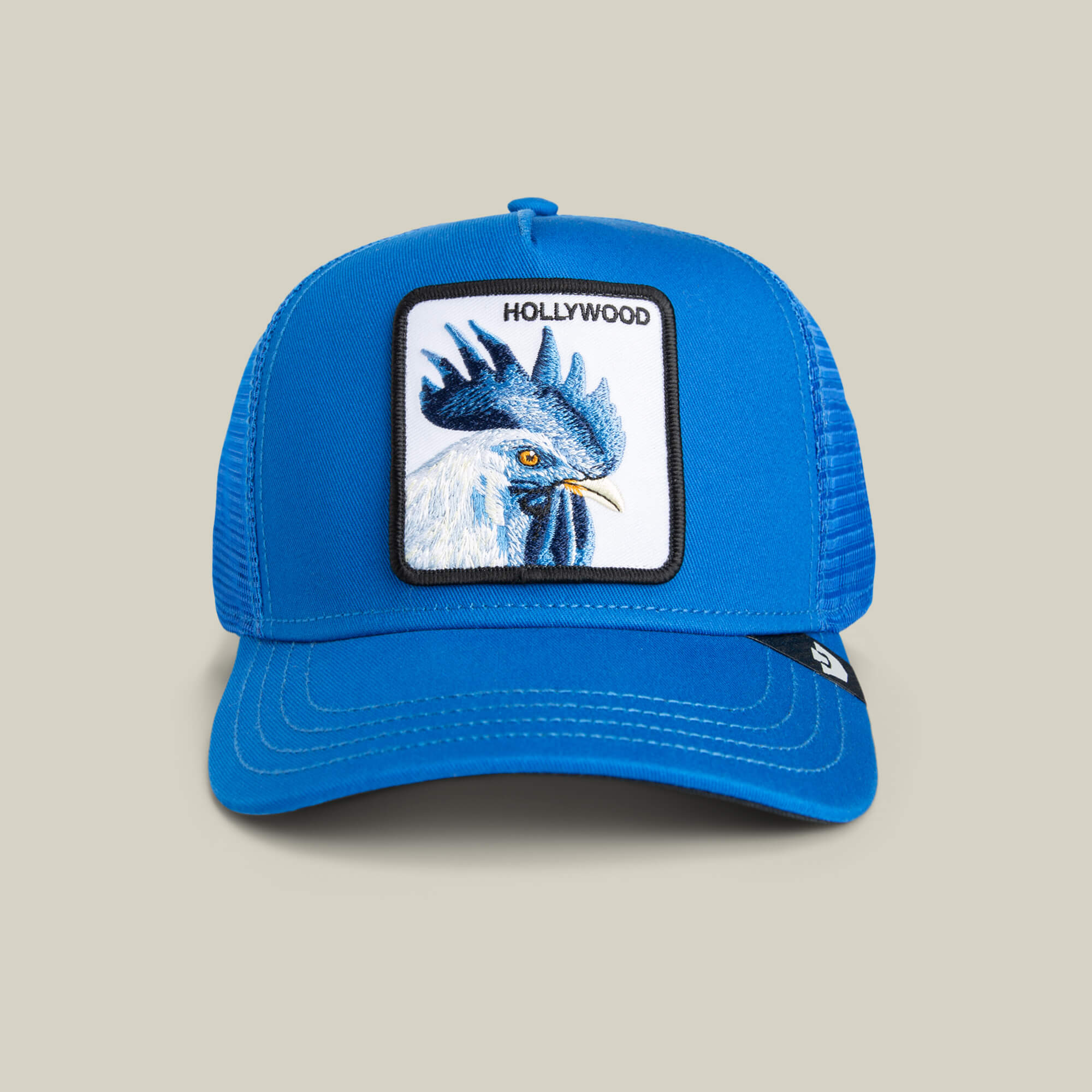 The Goorin Bros. Hollywood Rooster Mini is a blue trucker hat for kids, featuring electric blue mesh, a bold rooster patch, and "HOLLYWOOD" embroidered above it.