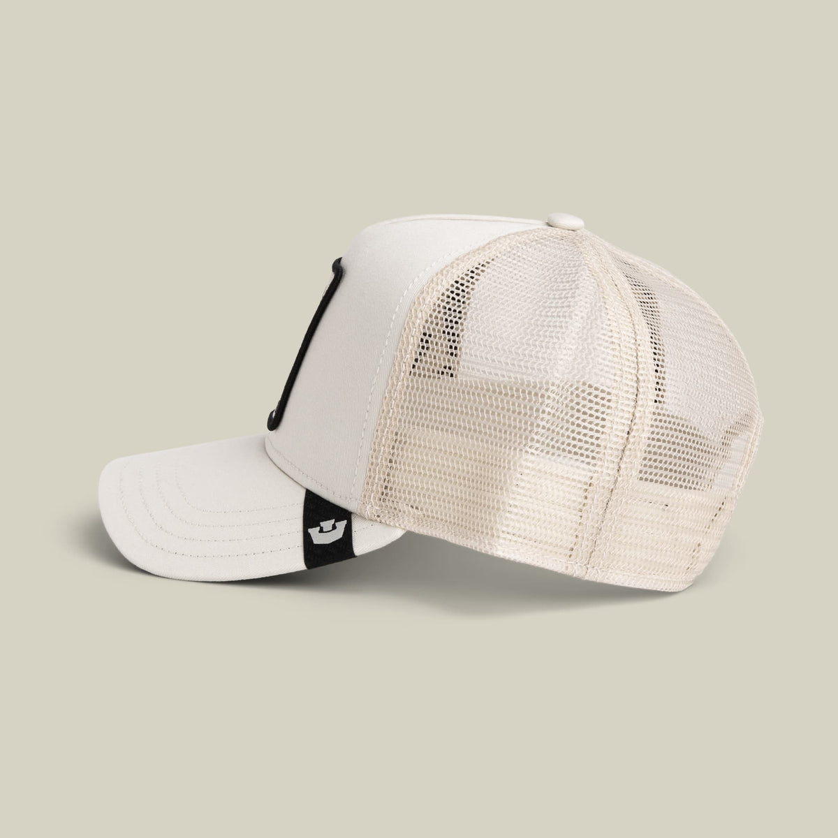 The Goorin Bros. Panther Trucker Mini is a white and cream mesh snapback cap with a black strap and small logo patch, shown in a studio product shot against a neutral background.
