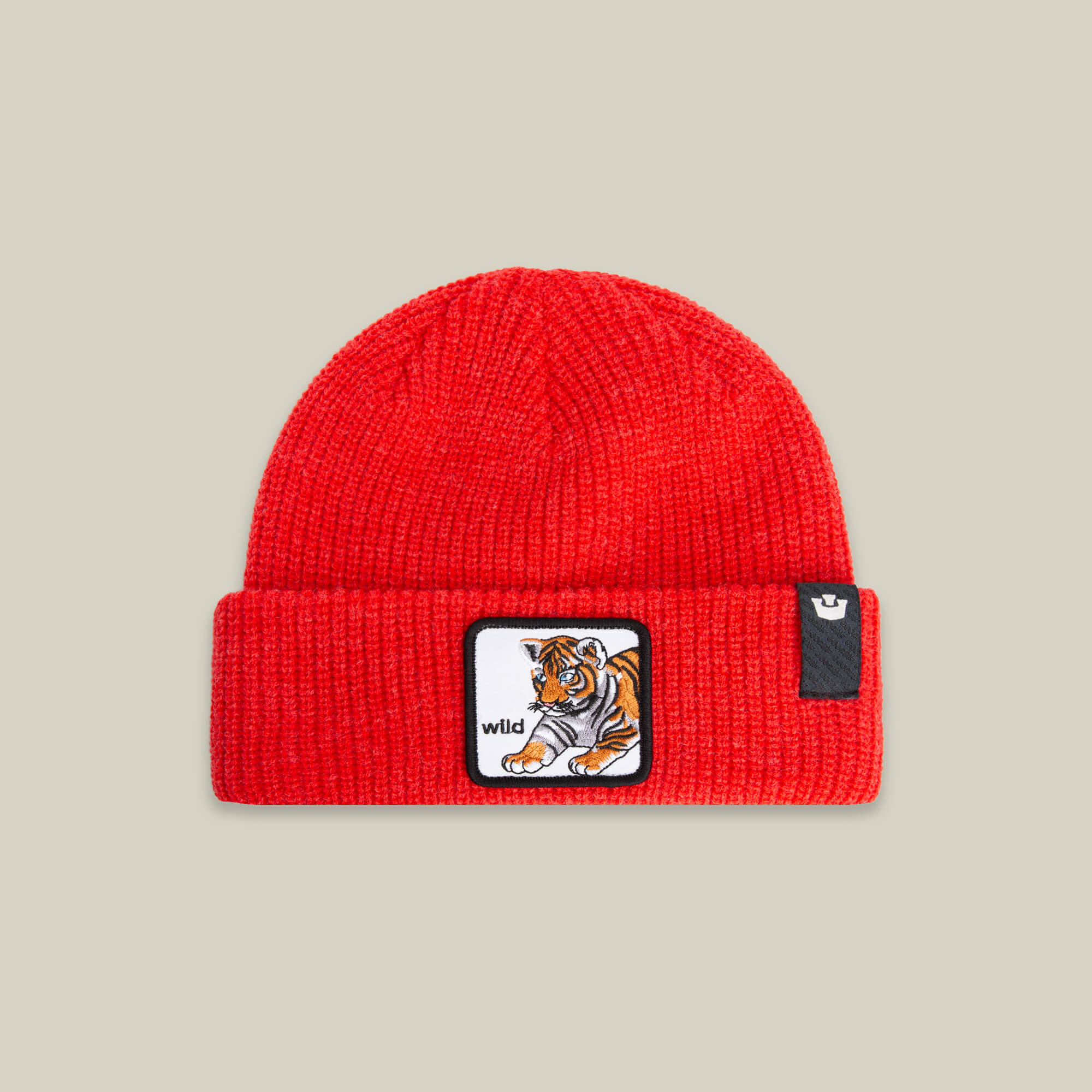 The Goorin Bros. Wild Beanie Mini is a bright red knit kids’ beanie, featuring a front tiger patch with "wild" and a small black logo tag on the cuff.