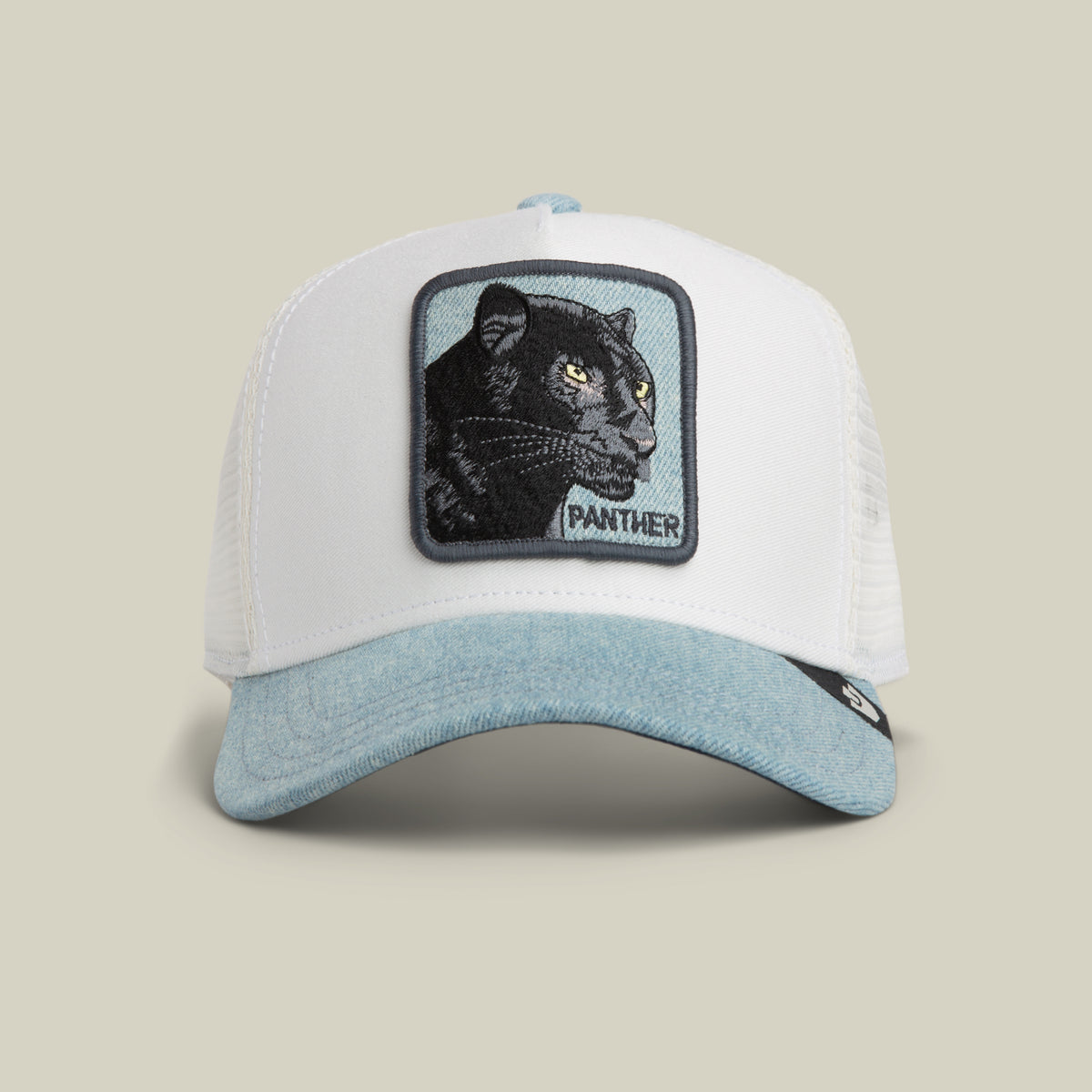 The Denim Panther by Goorin Bros. is a white and light blue trucker hat featuring a stitched patch of a black panther with the word “PANTHER” on the front, finished with a stylish denim brim.