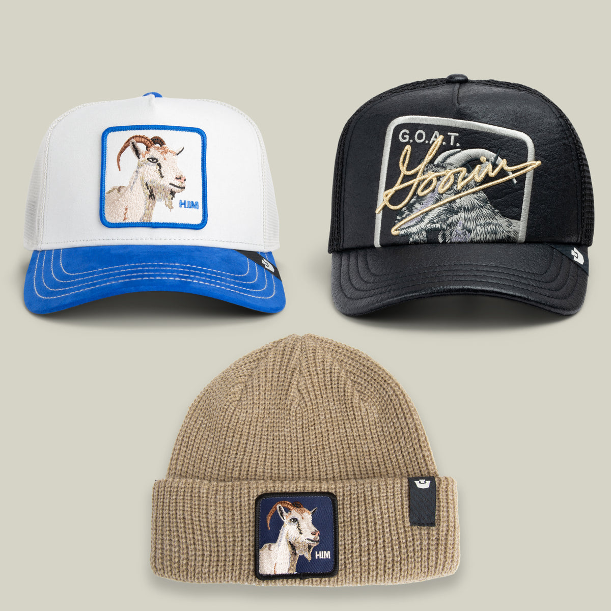 Three hats from the Goorin Bros. “How About of All Time? Bundle” are arranged on a neutral background: two trucker caps with goat graphics—one in white and blue, the other a black cap with bold G.O.A.T. text—and a tan beanie decorated with a small goat patch.
