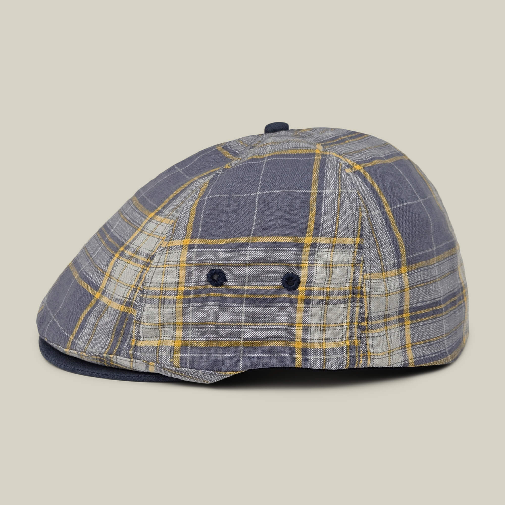 The Goorin Bros. Point Lobos is a gray, blue, and yellow plaid 6-panel Ivy flat cap featuring button accents and two small side ventilation holes. Crafted from a breathable cotton blend, it is displayed against a neutral background.