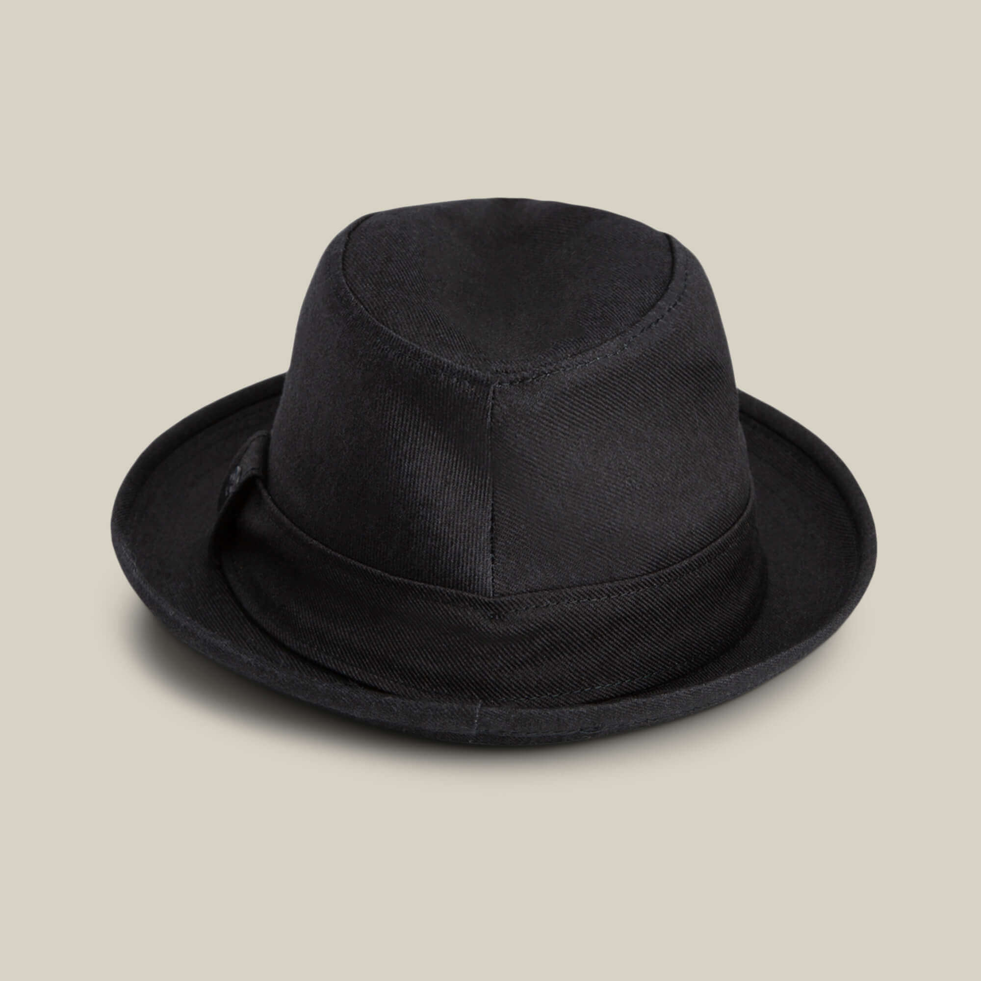 The Goorin Bros. Big Stepper is a stylish black fedora with a short brim and matching band, making it the perfect fashion accessory when showcased on a neutral beige background.