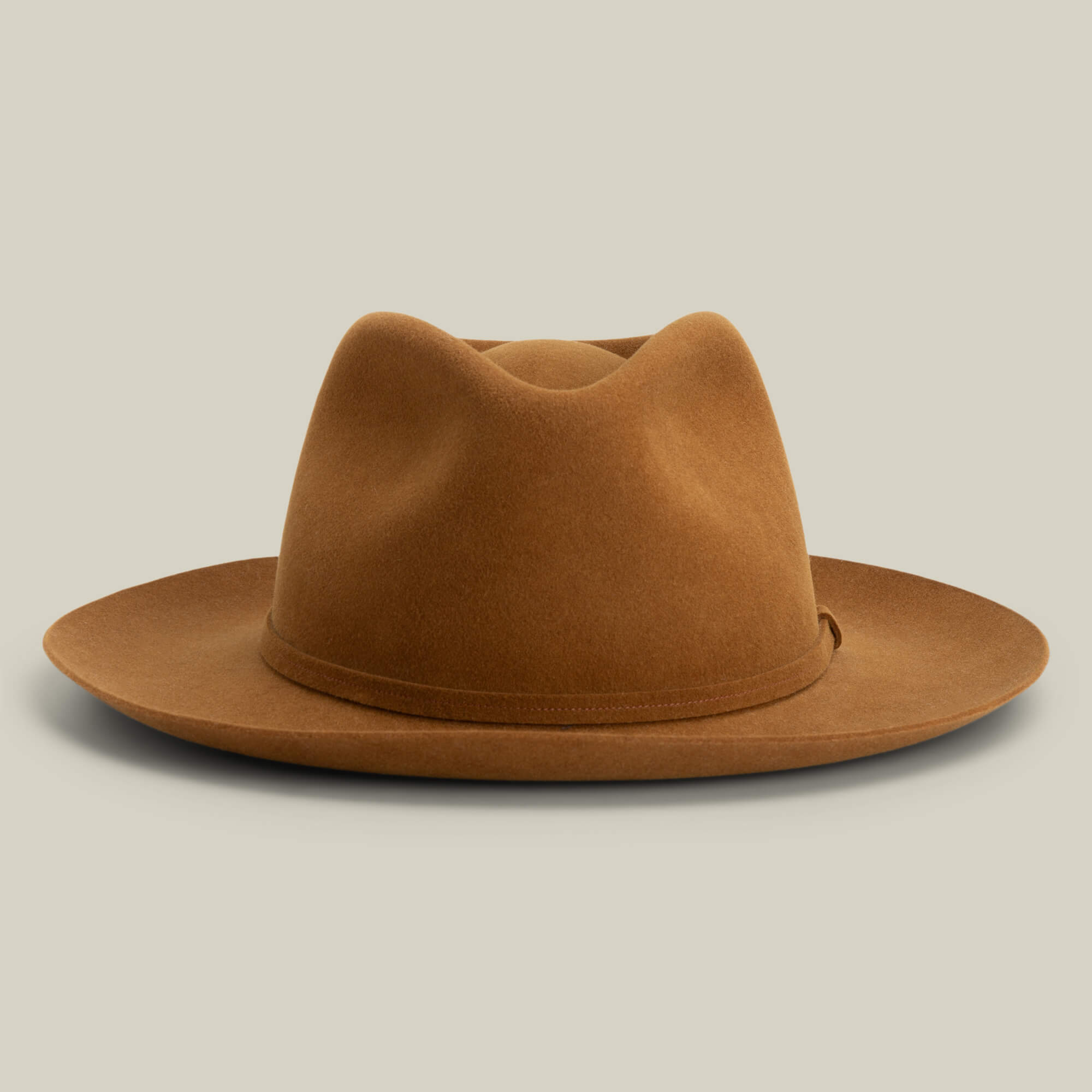 The Night Hawk by Goorin Bros. is a brown felt teardrop crown fedora with a wide snap brim, shown on a plain light background—an all-season hat for versatile style.