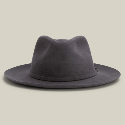 The Night Hawk by Goorin Bros. is a dark grey felt fedora featuring a teardrop crown, wide snap brim, and simple hatband—an elegant all-season accessory for any occasion, shown on a neutral background.