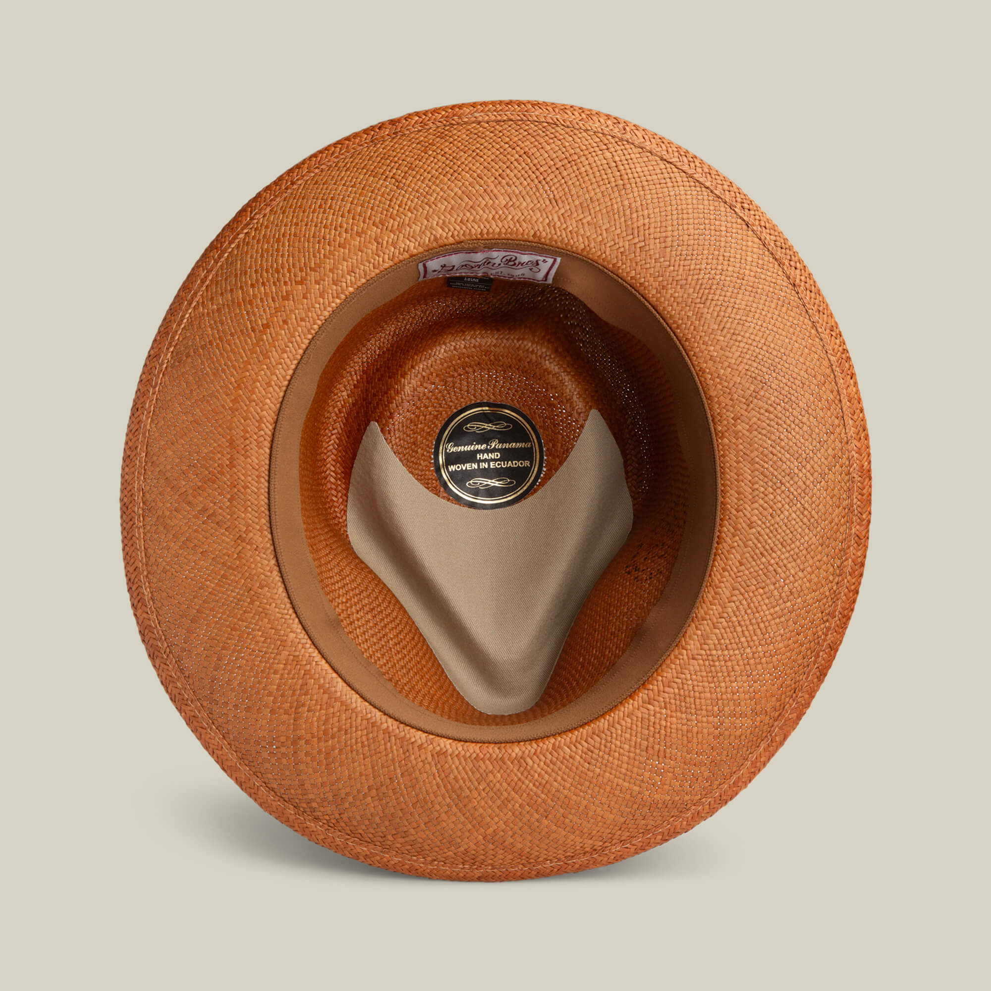 Top-down view of the John Sr. toquilla teardrop fedora by Goorin Bros., showing a fabric sweatband and label noting it's handmade in Ecuador with 50 UPF sun protection.