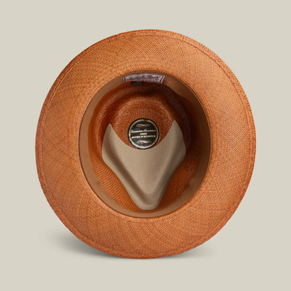 Top-down view of the John Sr. toquilla teardrop fedora by Goorin Bros., showing a fabric sweatband and label noting it's handmade in Ecuador with 50 UPF sun protection.
