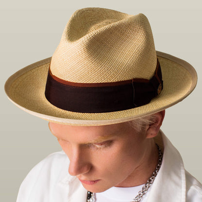 A person wears the Goorin Bros. Hartman, a light straw fedora with grosgrain band and 50 UPF protection, viewed from above against a plain background.