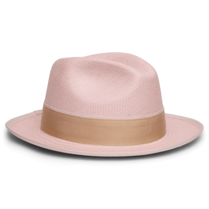 The Goorin Bros. Hartman is a light pink fedora made from 100% toquilla, featuring a wide beige grosgrain band and contrasting edge binding, shown on a white background.