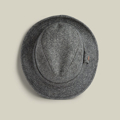 The Shady Tweed Fedora by Goorin Bros., in gray Shetland wool with a narrow brim, is shown from above on a plain beige background.