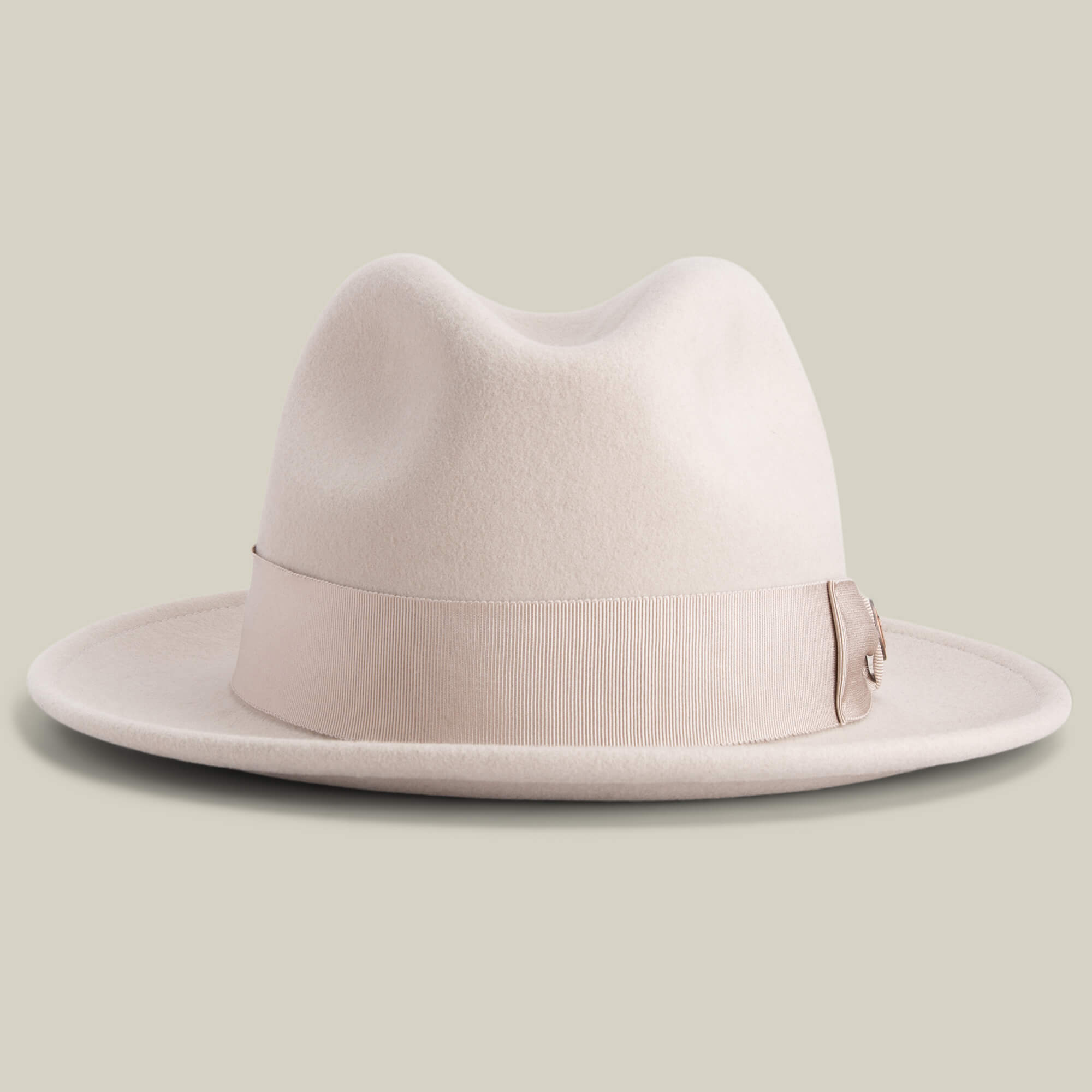 Dean the Butcher by Goorin Bros. is a beige felt fedora with a wide brim, matching ribbon band, and German wicking sweatband, shown on a plain light background.