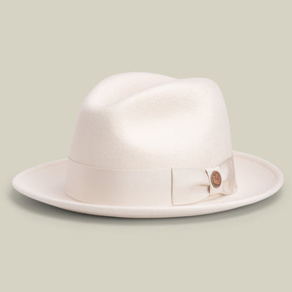 Dean the Butcher by Goorin Bros. is an American-made fedora in DUST, featuring a wide brim and a matching ribbon band, displayed on a neutral background.