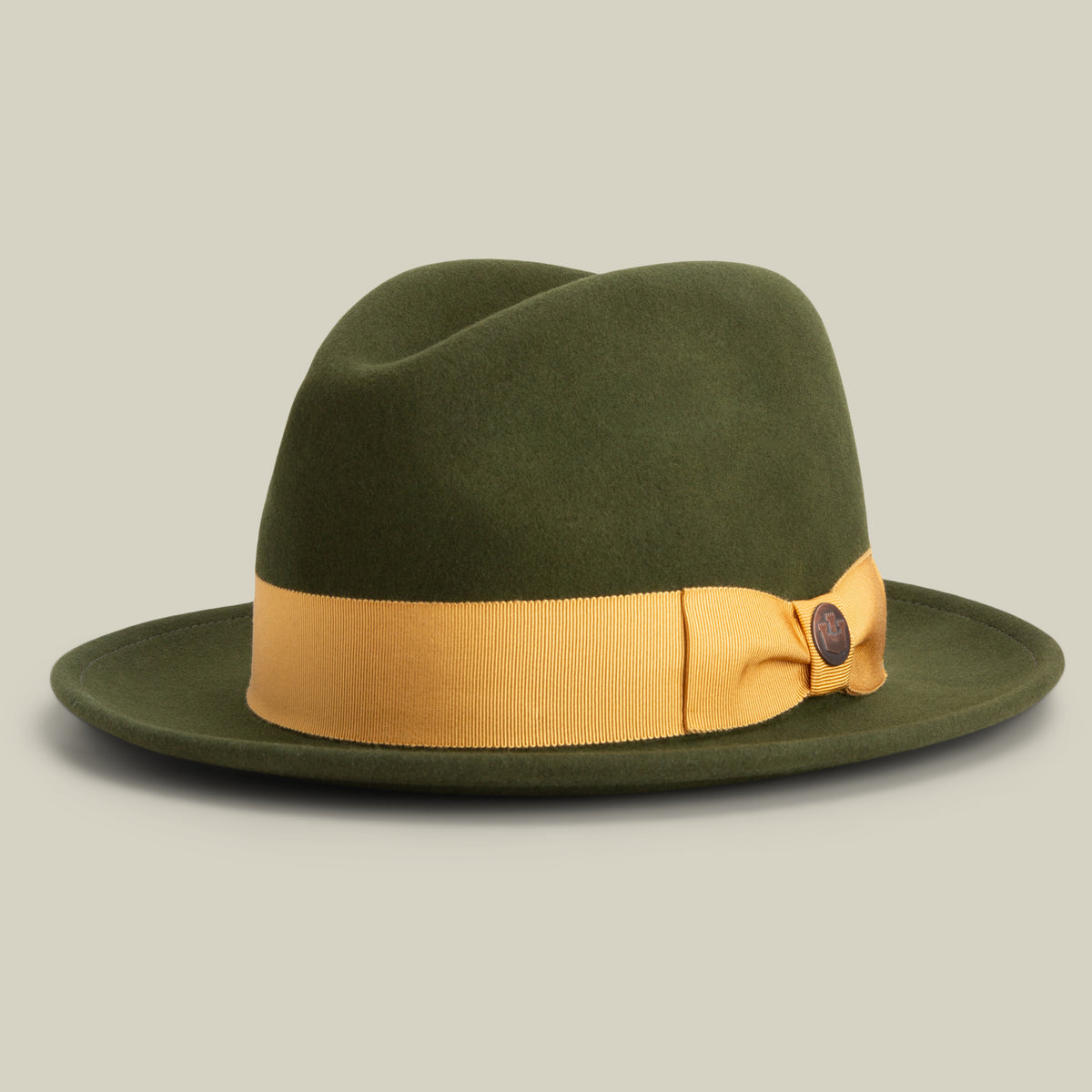 Here is your revised sentence using the provided product data: Dean the Butcher by Goorin Bros. is an elegant all-season fedora in PALM, featuring felt construction, a wide brim, and a yellow ribbon band with a small decorative bow on the side—all set against a plain light background and proudly American-made for any wardrobe.