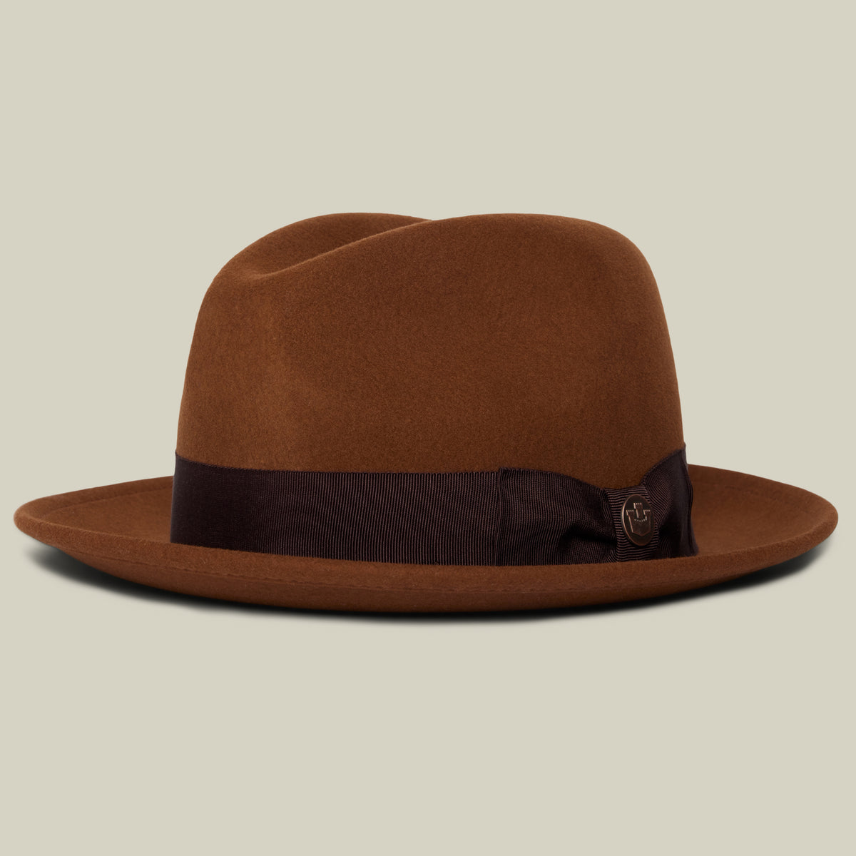 The Goorin Bros. “Dean the Butcher” fedora, expertly crafted in whiskey-colored felt, showcases a dark brown ribbon band with a small bow, displayed on a plain background.
