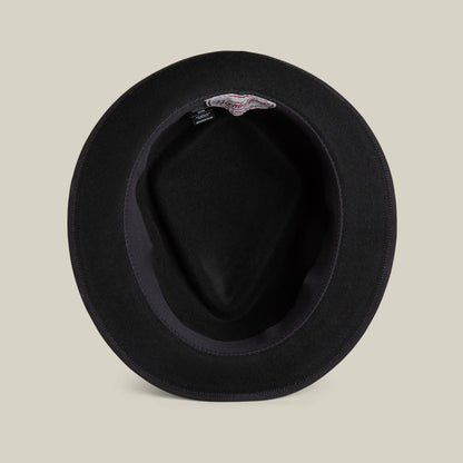 A black felt Slick Carter hat by Goorin Bros. seen from above, highlighting its interior lining and a discreet label near the inner brim—showcasing classic short-brim wool style.