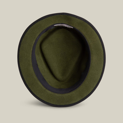 Top view of the Goorin Bros. Slick Carter olive green wool short brim felt hat with a black inner band, styled on a plain beige background.