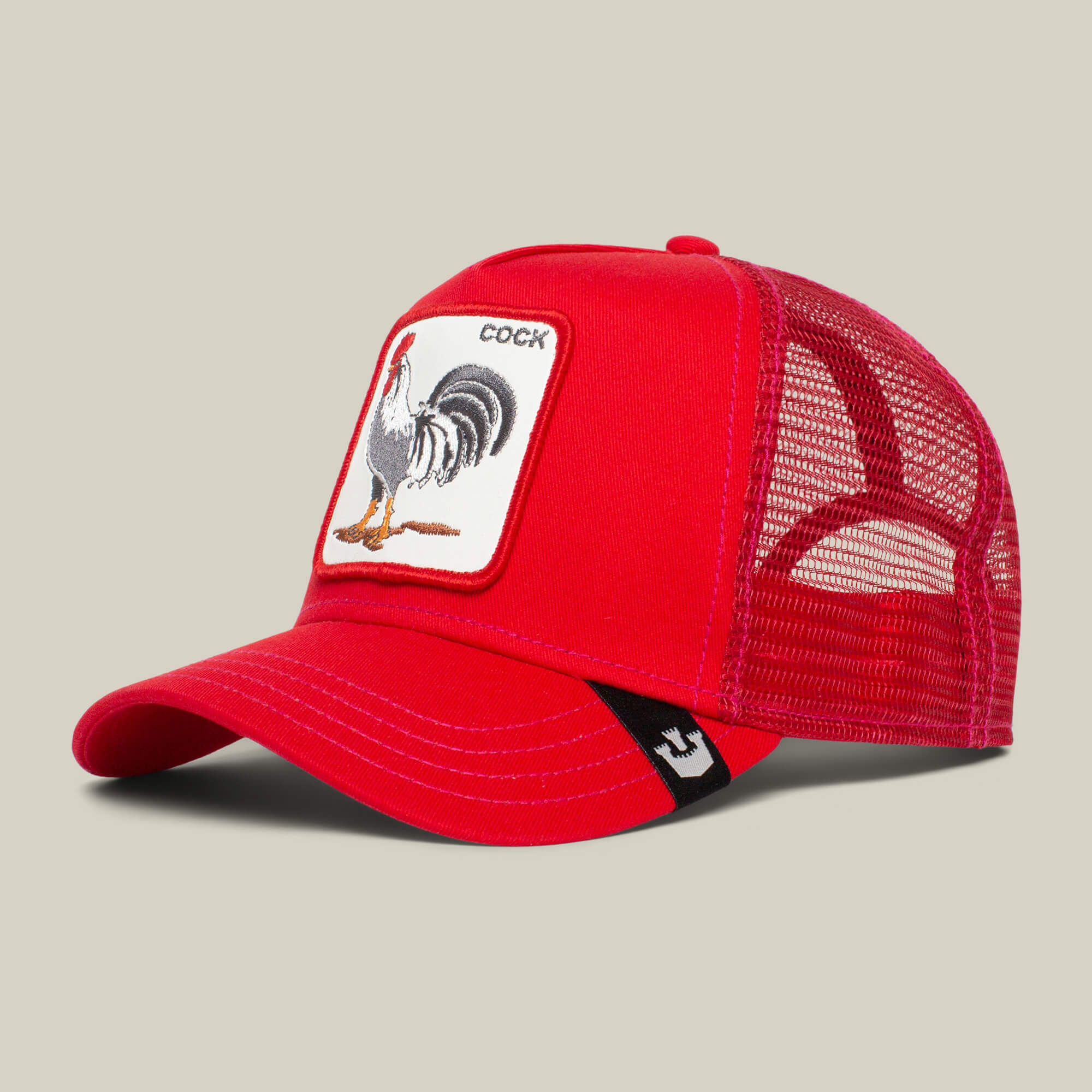 The Farm's "The Cock" cap is a red mesh baseball hat with a curved brim and a rooster patch next to the word COCK on the front.