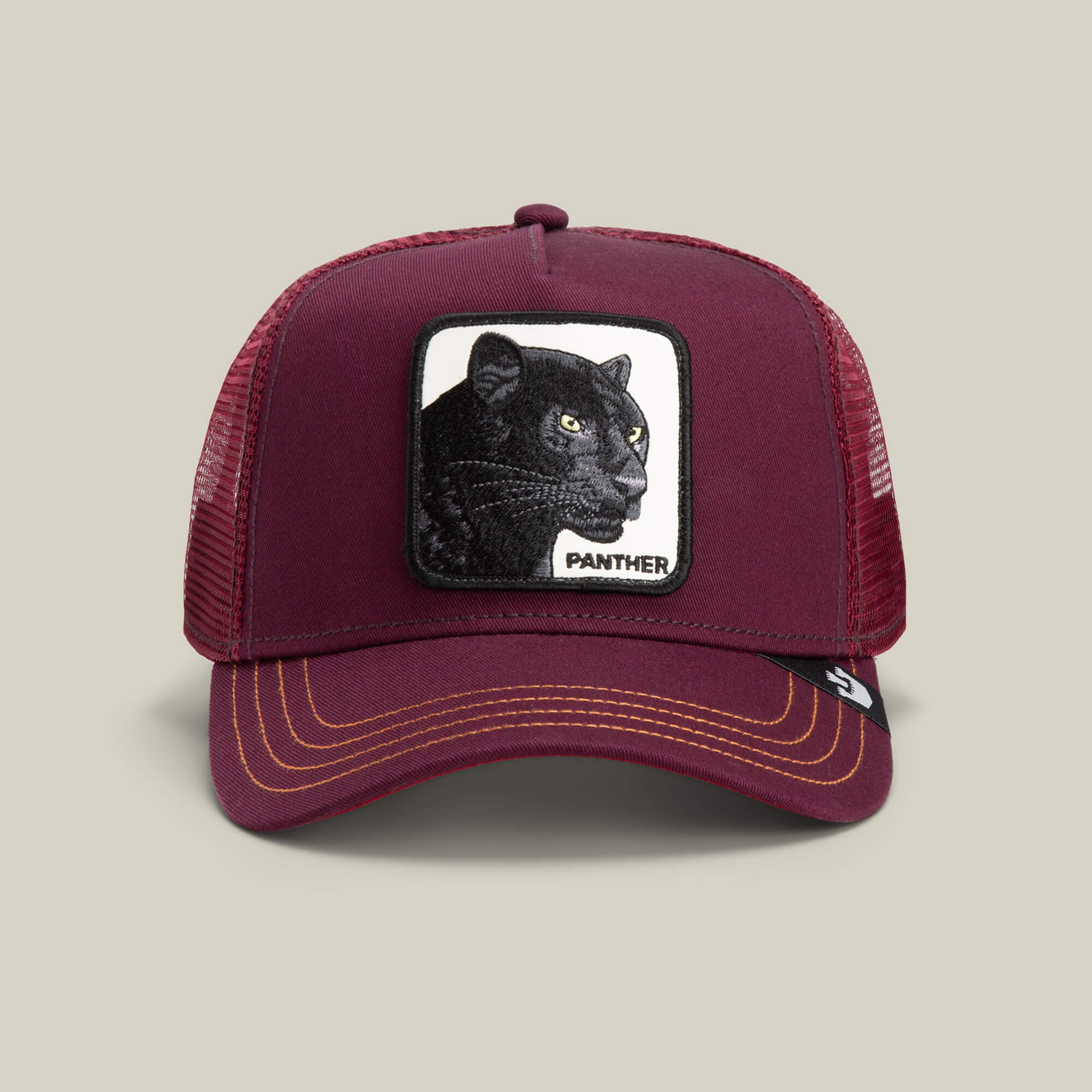 The Panther by Goorin Bros. is a maroon trucker hat with yellow stitching, featuring a black panther patch and "PANTHER" on the front—part of The Farm collection.