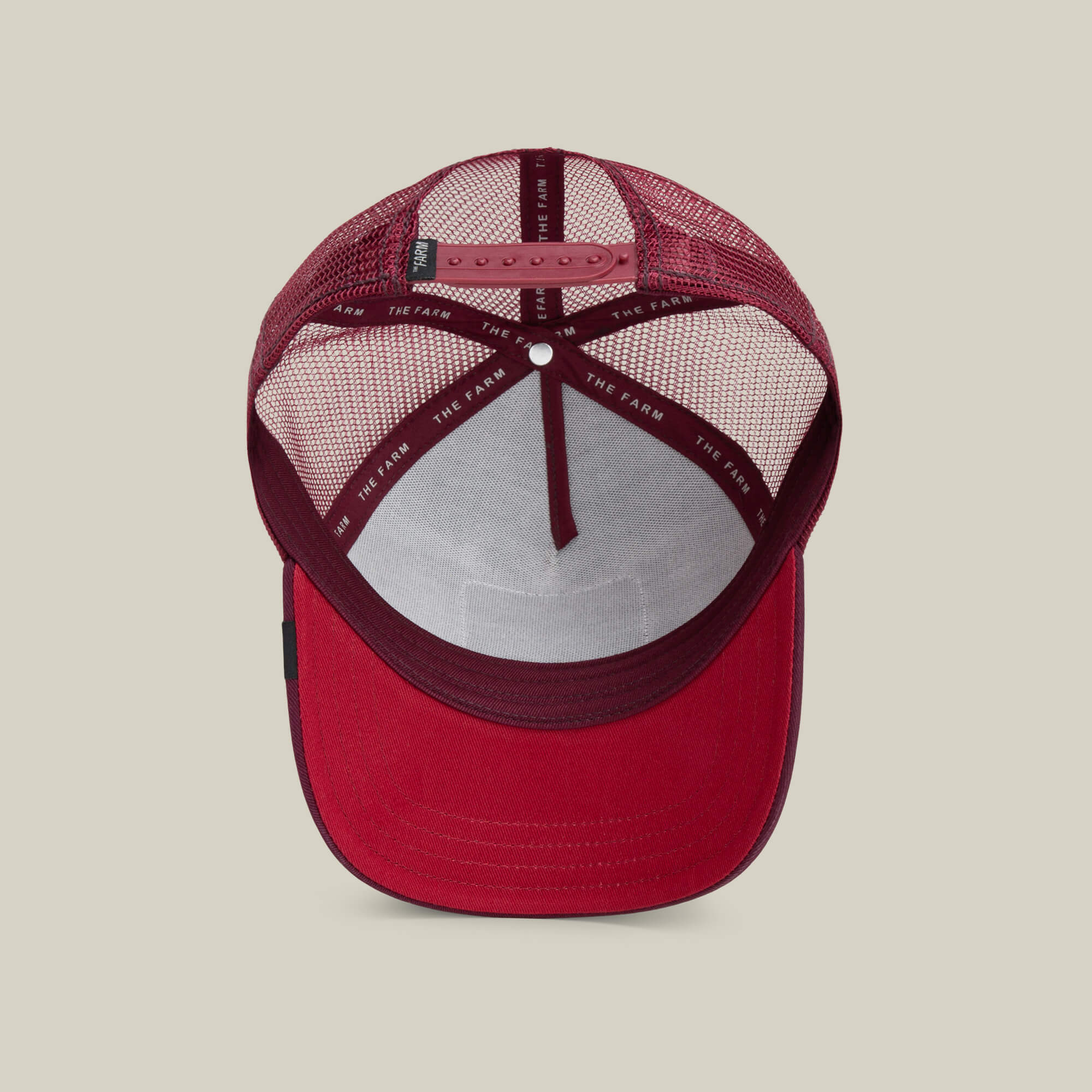 A red "The Panther" mesh trucker baseball hat by Goorin Bros., viewed from above, features an adjustable snapback strap and an interior headband labeled THE FARM.