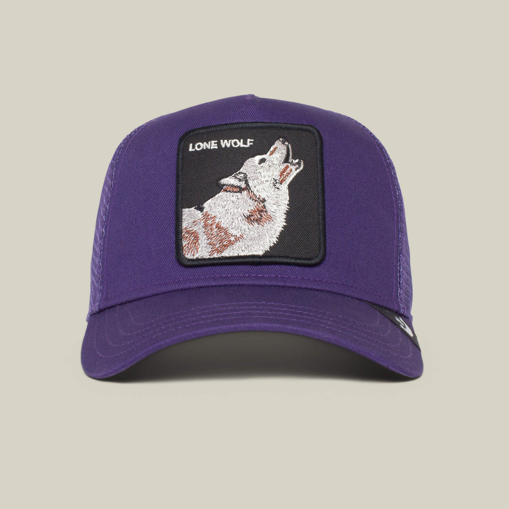 The Lone Wolf by The Farm is a purple trucker hat featuring a front patch with a howling wolf and "LONE WOLF" text—ideal for independent spirits and true anti-conformists.