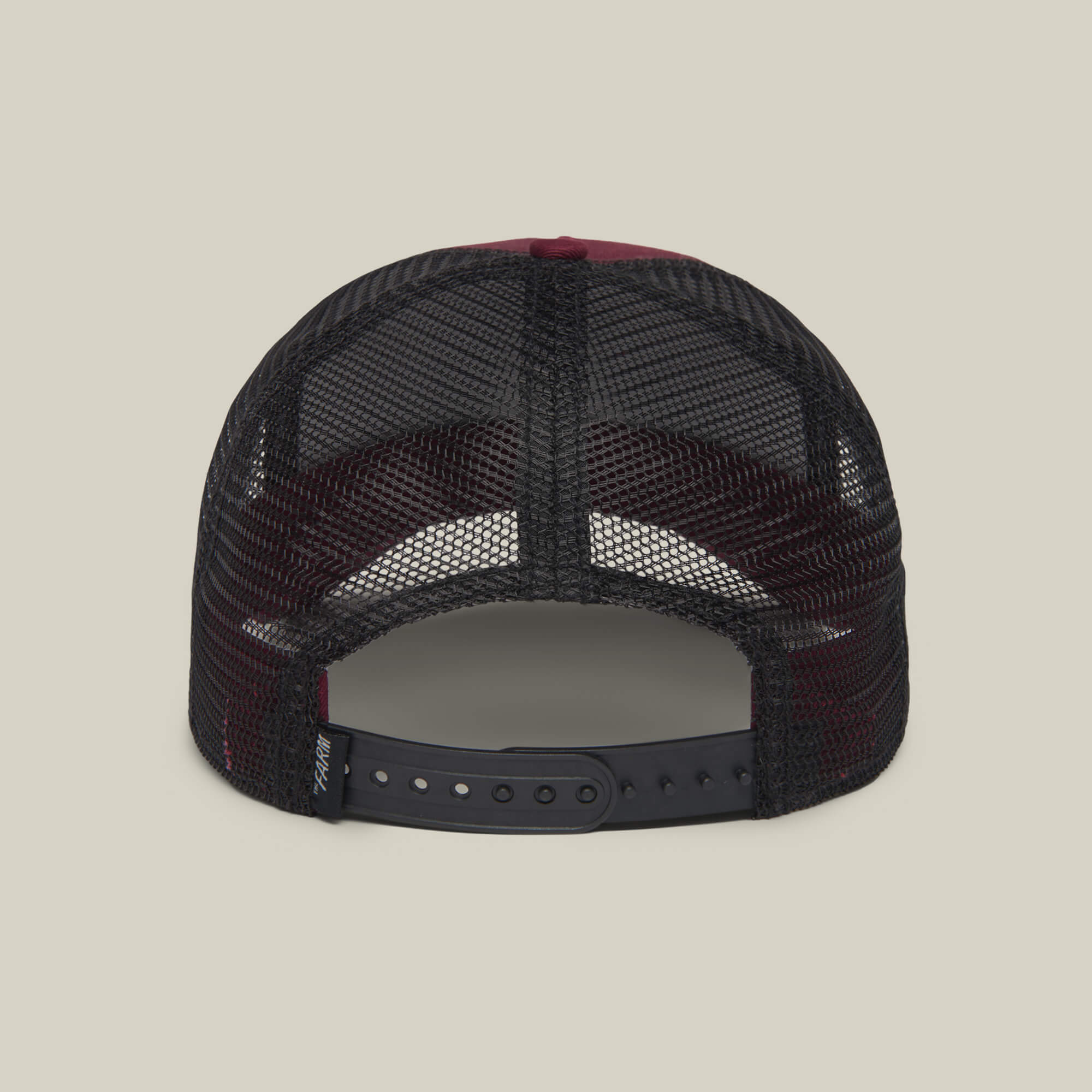 Back view of The Farm's "The Lone Wolf" black mesh trucker hat with adjustable snapback, perfect for independent spirits, shown against a plain background.