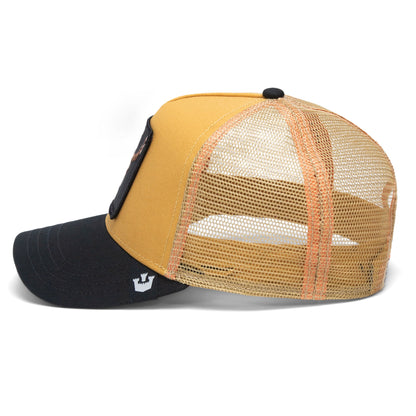 The Farm’s "The Dead Skull" trucker hat features a mustard yellow front panel, black brim, and beige mesh back, shown from the side. All sales are final.