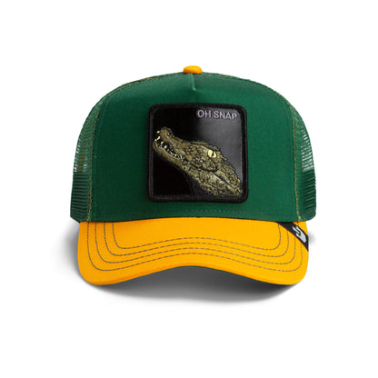 The Oh Snap Alligator by The Farm is a green and yellow trucker hat with a mesh back and a front patch featuring an alligator head and the text OH SNAP. All sales final.