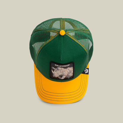 The Farm's "The Bulletproof Rhino" is a green and yellow trucker hat with mesh panels, yellow stitching, and a front patch of a rhinoceros and "BULLETPROOF." All sales are final.