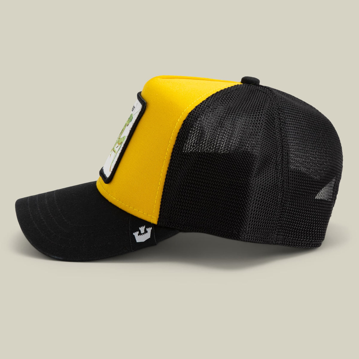 The Heartbreaker by Goorin Bros is a yellow and black color-block trucker hat with a mesh back and snapback closure, featuring a small patch on the front and brand logo on the side, displayed against a neutral studio background.