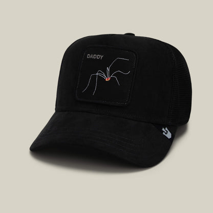 The Suede Spider by Goorin Bros. is a black trucker hat with a patch showing an embroidered spider and the word DADDY, making it a fun arachnid-themed dad gift.