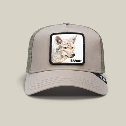 The Farm's "The Bandit Coyote" is a khaki mesh baseball cap featuring a front patch with a coyote drawing and the word BANDIT—perfect for those with an adventurous spirit.