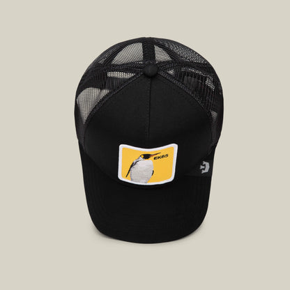 The EK65 Penguin limited edition black mesh trucker hat by Goorin Bros. features a front patch with a penguin on a yellow background and EK65 text.